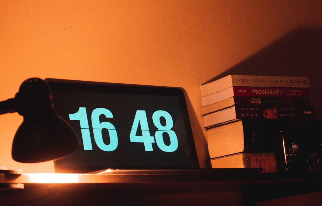 black digital clock reading at 16 48 - Photo by MICHEL ANDRADE on Unsplash