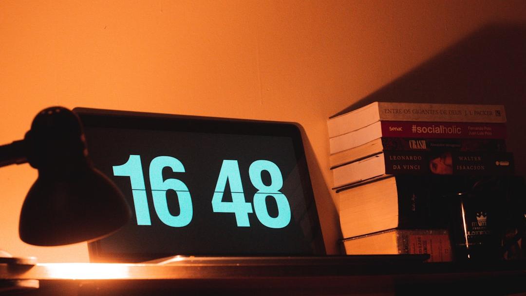 black digital clock reading at 16 48 - Photo by MICHEL ANDRADE on Unsplash