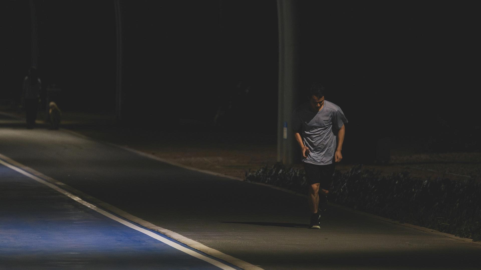 man jogging in the dark