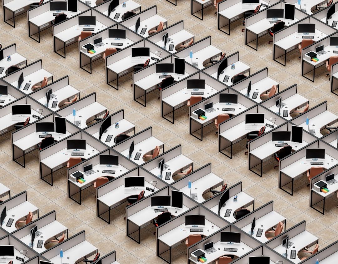 a room filled with lots of desks and computers - Photo by Igor Omilaev on Unsplash