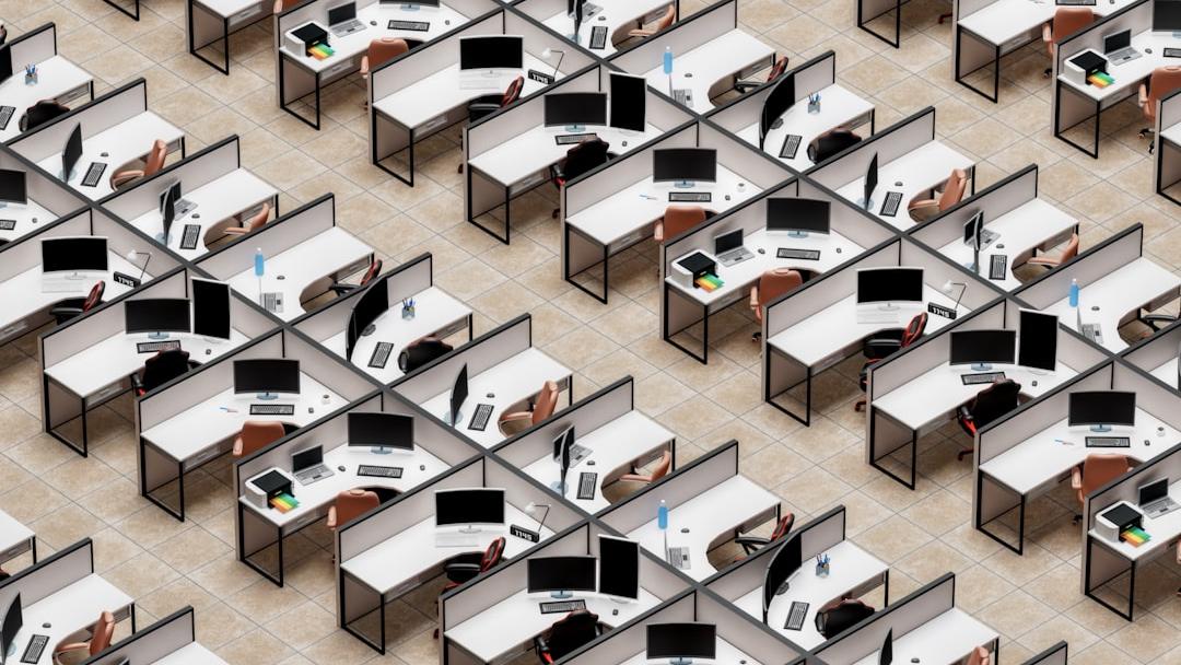 a room filled with lots of desks and computers - Photo by Igor Omilaev on Unsplash