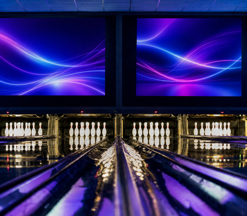 Four bowling lanes in the blue-and-violet-lit VIP area.