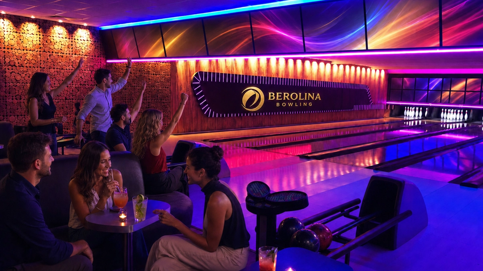 Adults bowl and socialise beside colourfully lit lanes.