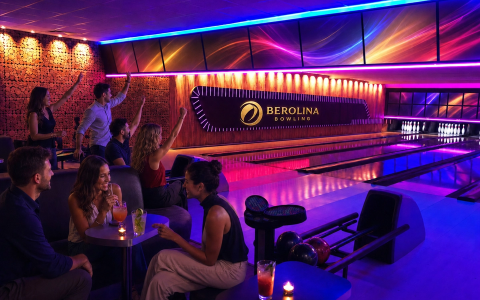 Adults bowl and socialise beside colourfully lit lanes.