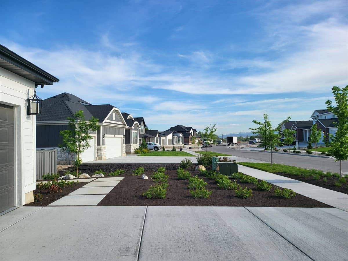 Custom sprinkler system and landscape design with boulder wall in Salt Lake City.