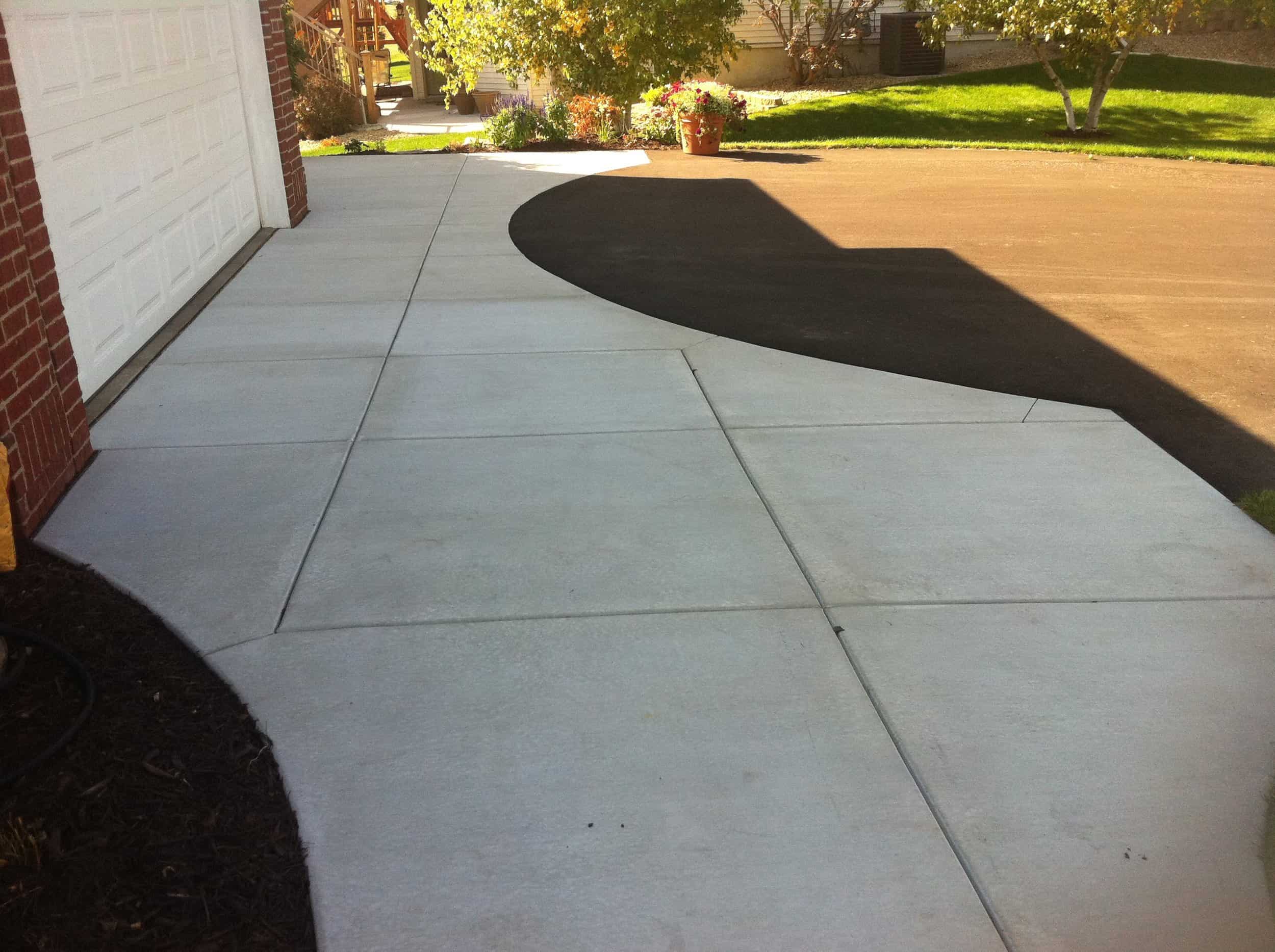 Gray concrete pad in Herriman, Utah by Pitt Landscape & Construction.