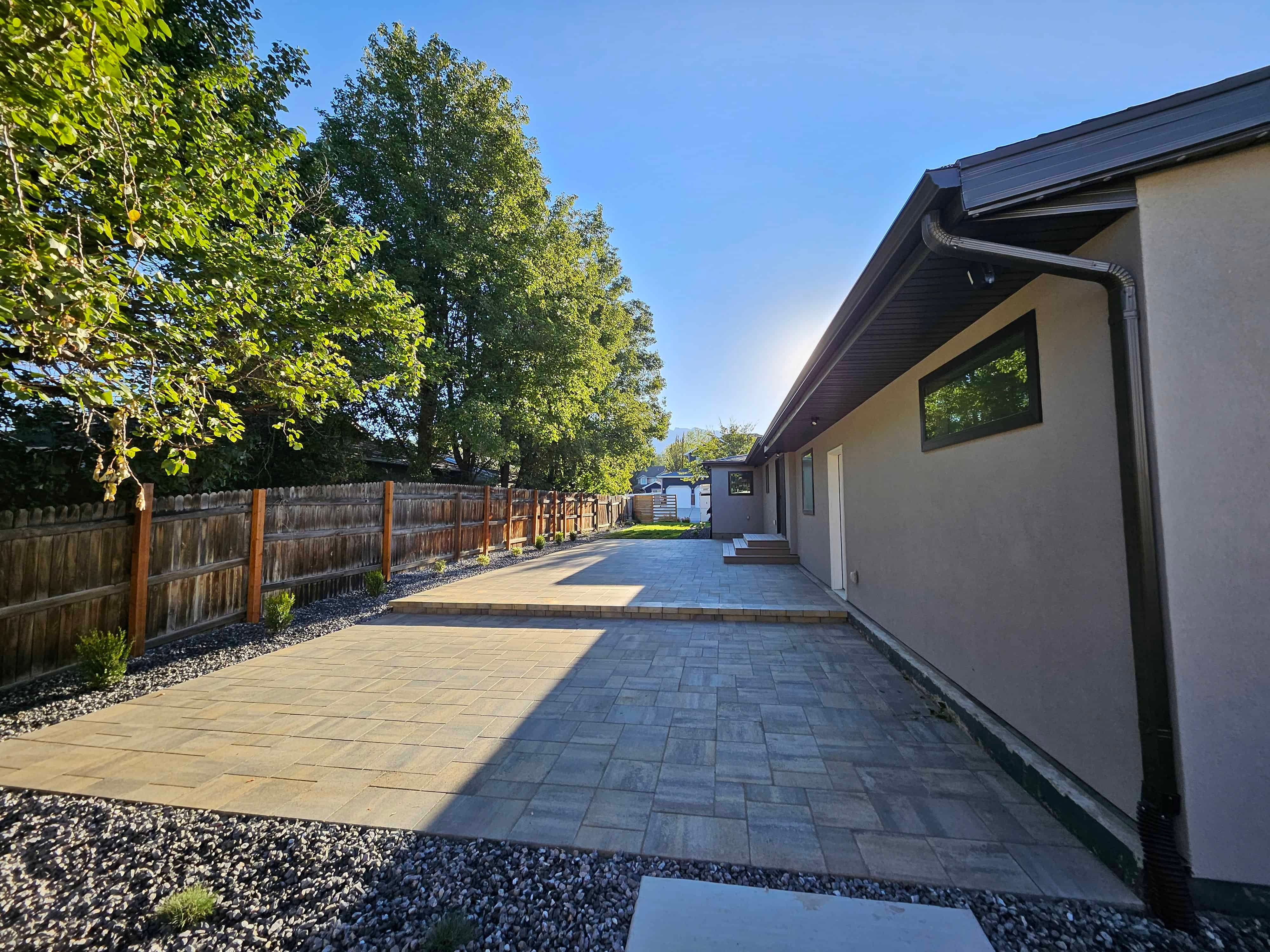 Tan-colored pavers patio in Murray, Utah designed by Pitt Landscape & Construction