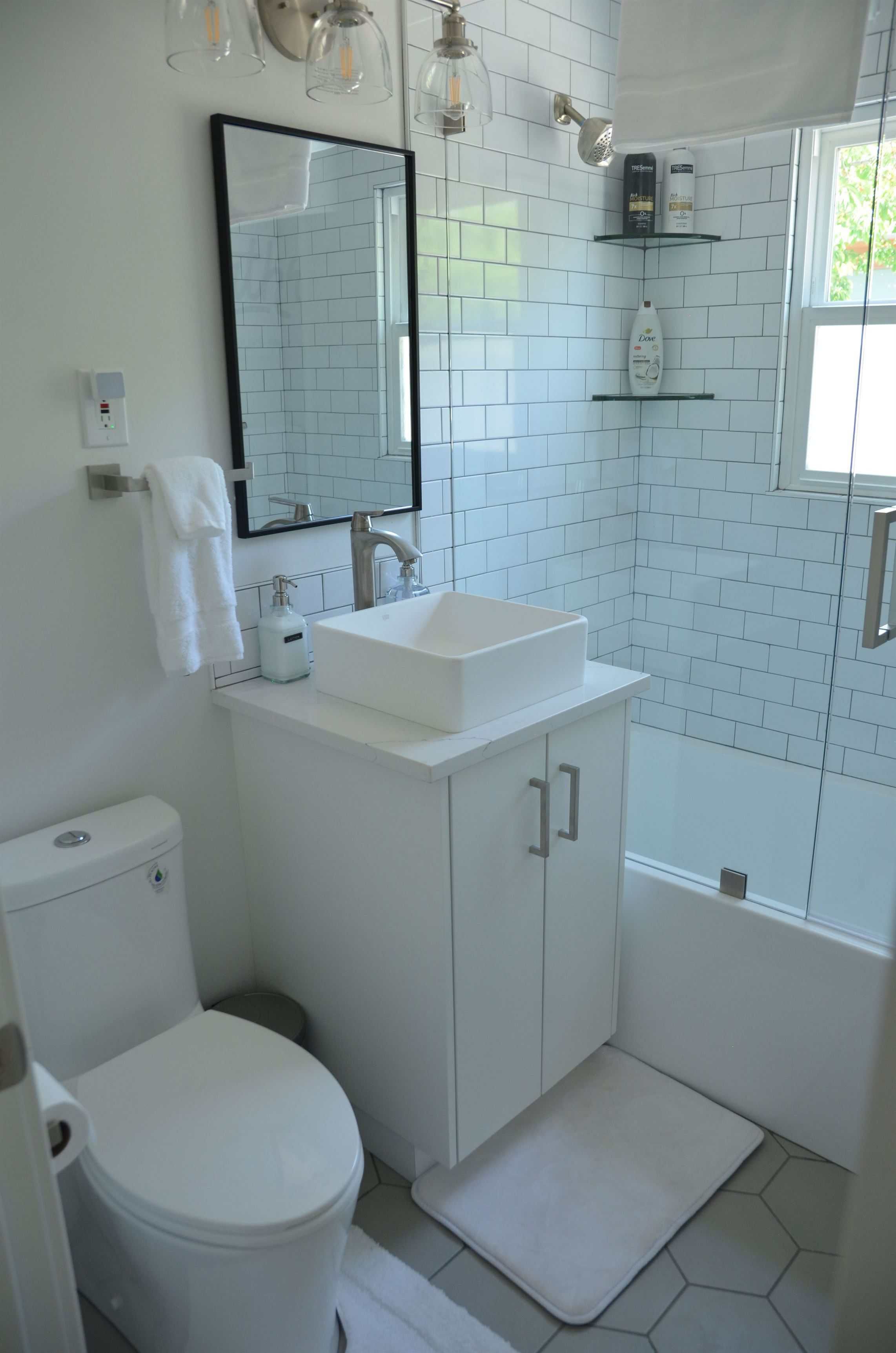 Bathroom with custom tile, glass shower, and cabinets in Sugarhouse, Salt Lake City remodel.
