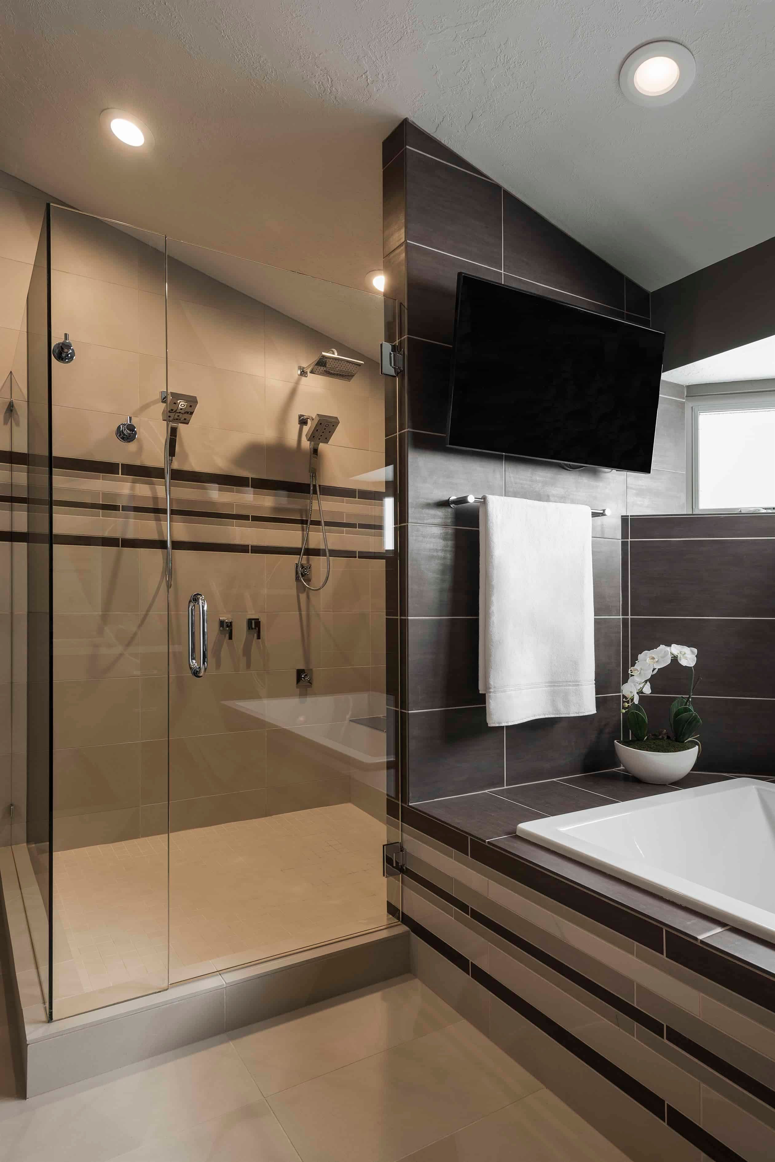 Tile shower with glass door in Salt Lake City bathroom remodel.