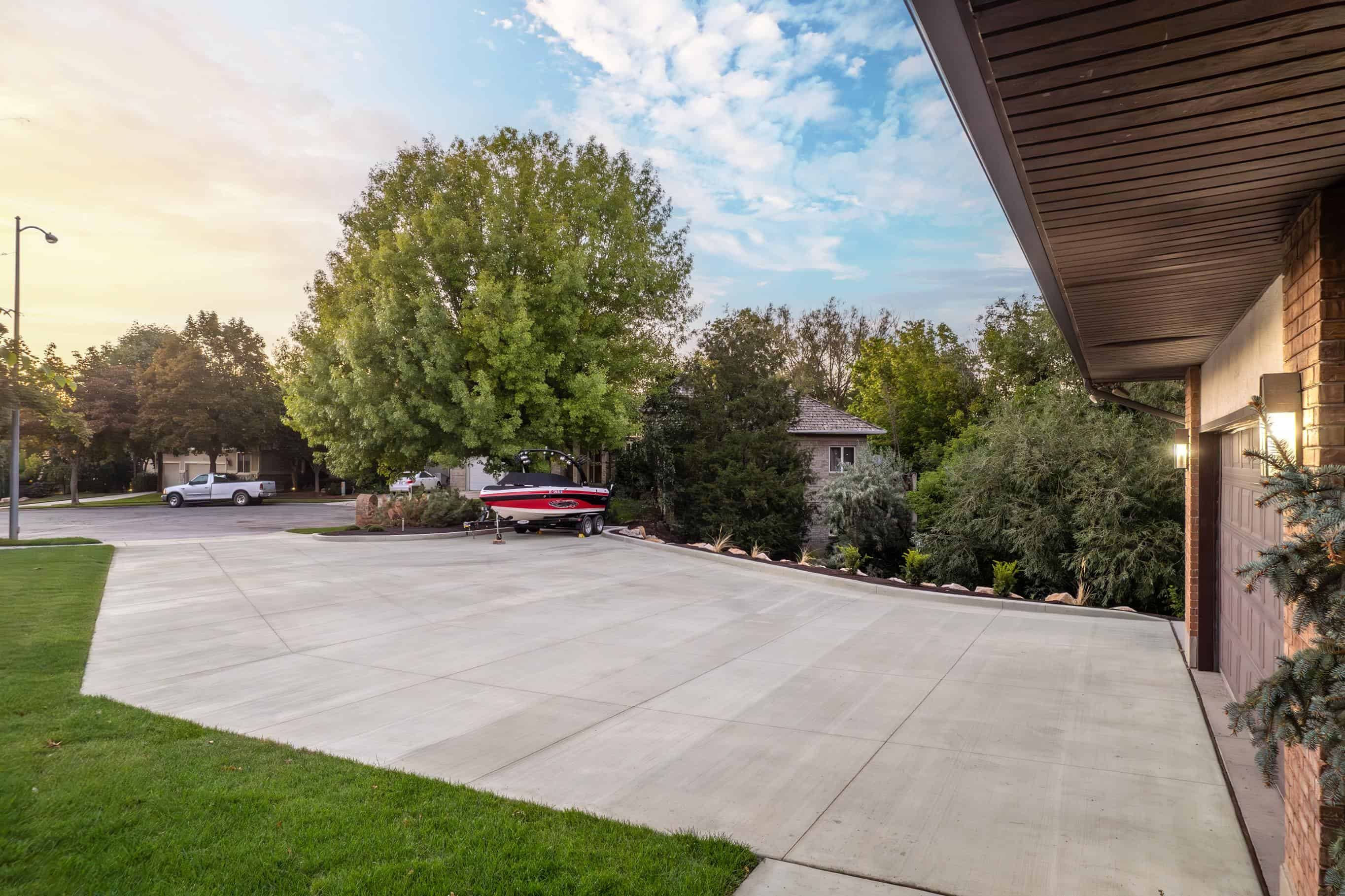 Gray concrete driveway installed by Pitt Landscape in Murray, Utah.