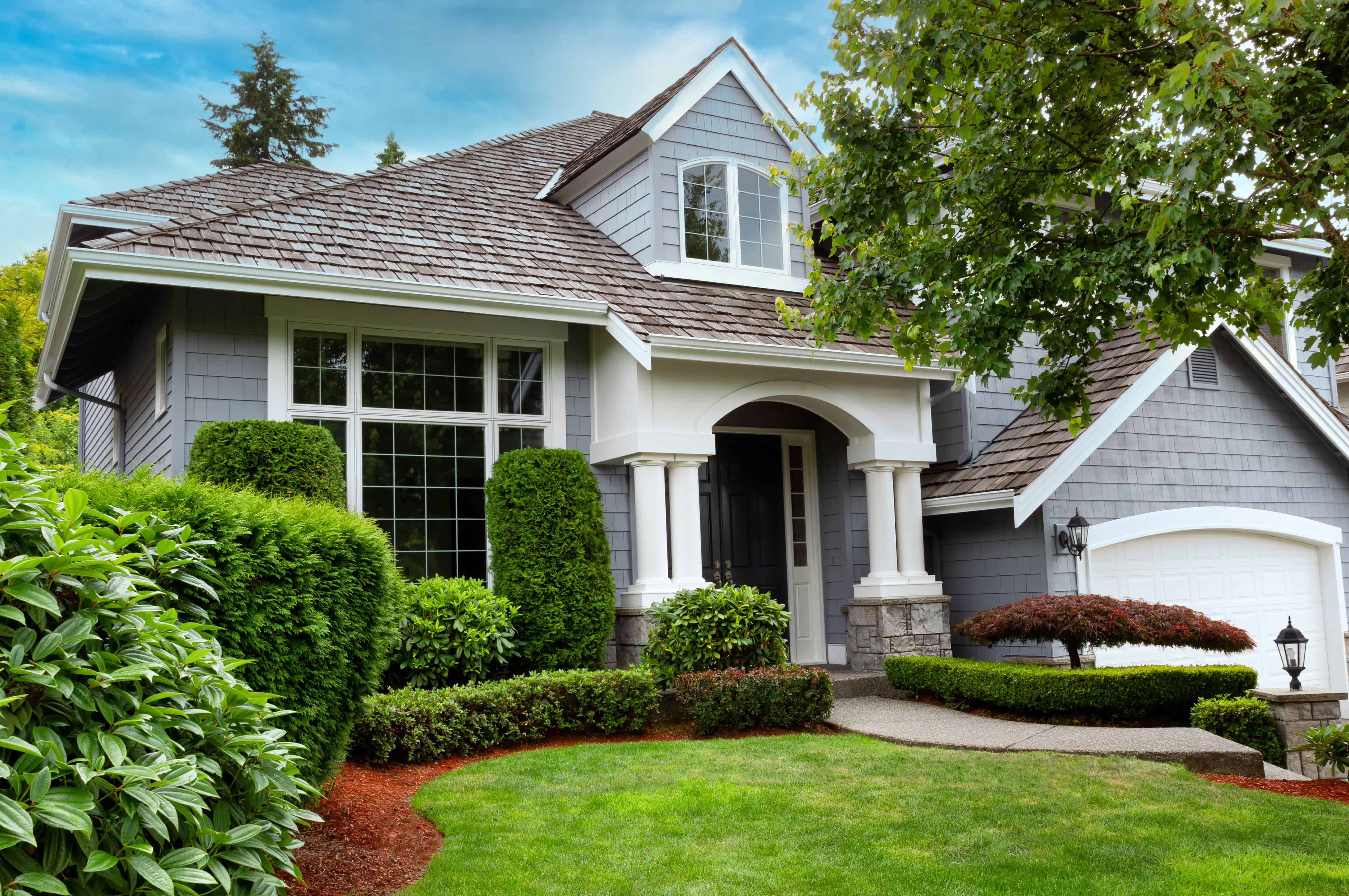 Yard maintenance service showcasing a well-maintained yard with lush grass and trimmed shrubs.