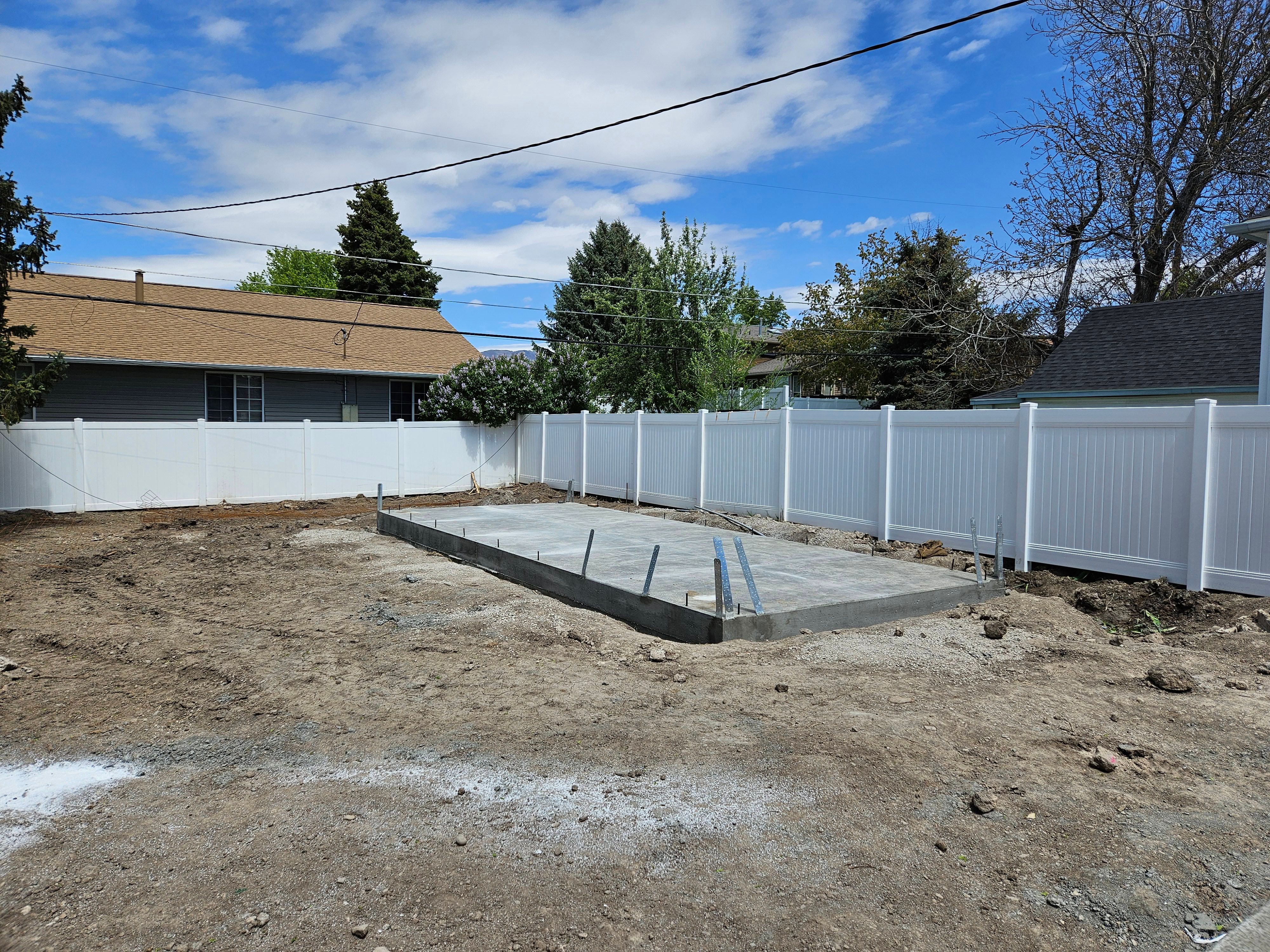 Garage foundation under construction in Millcreek showing concrete footings and slab preparation.