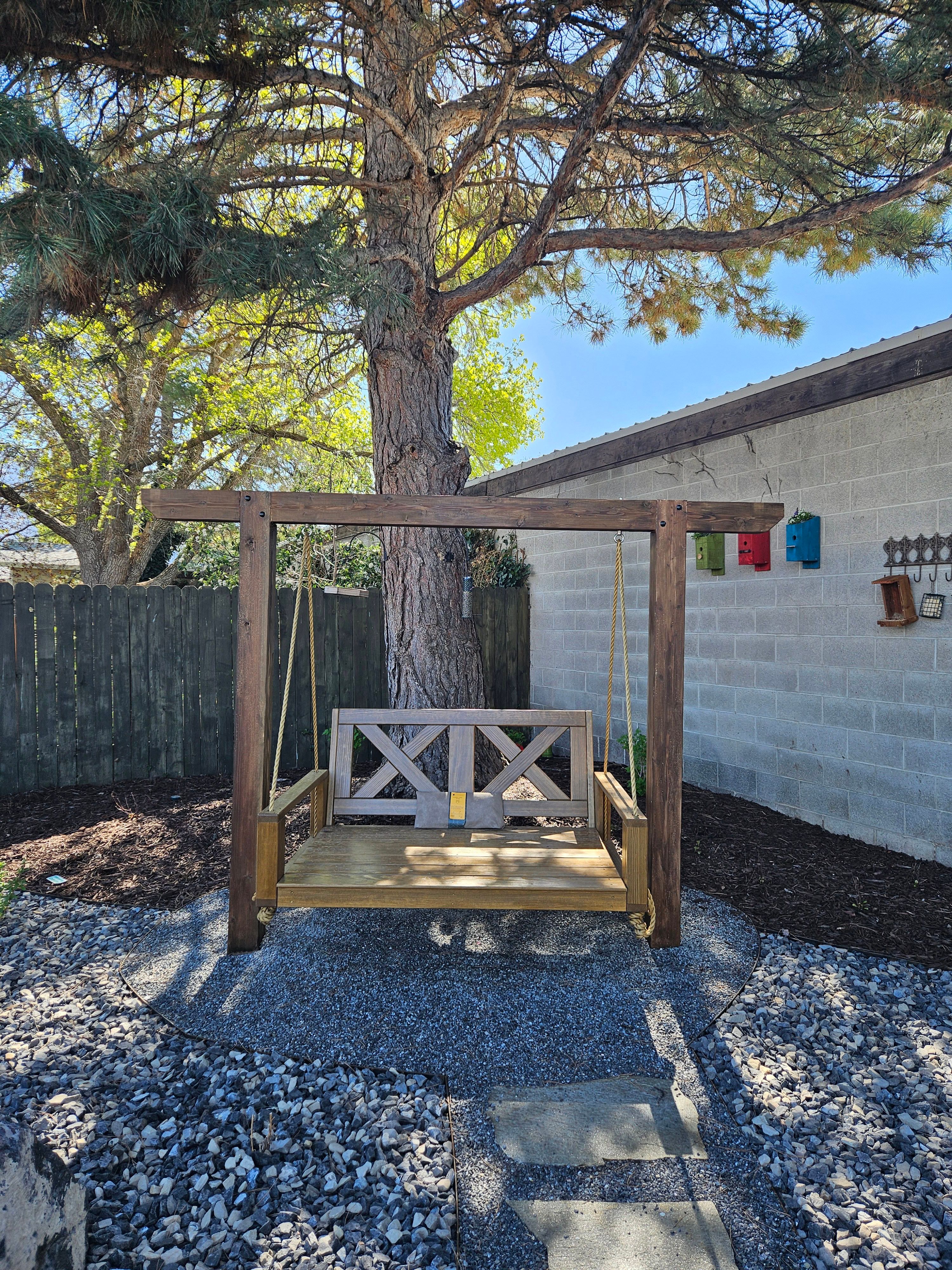 Wooden swing structure installed in a landscaped backyard in Murray, Utah.