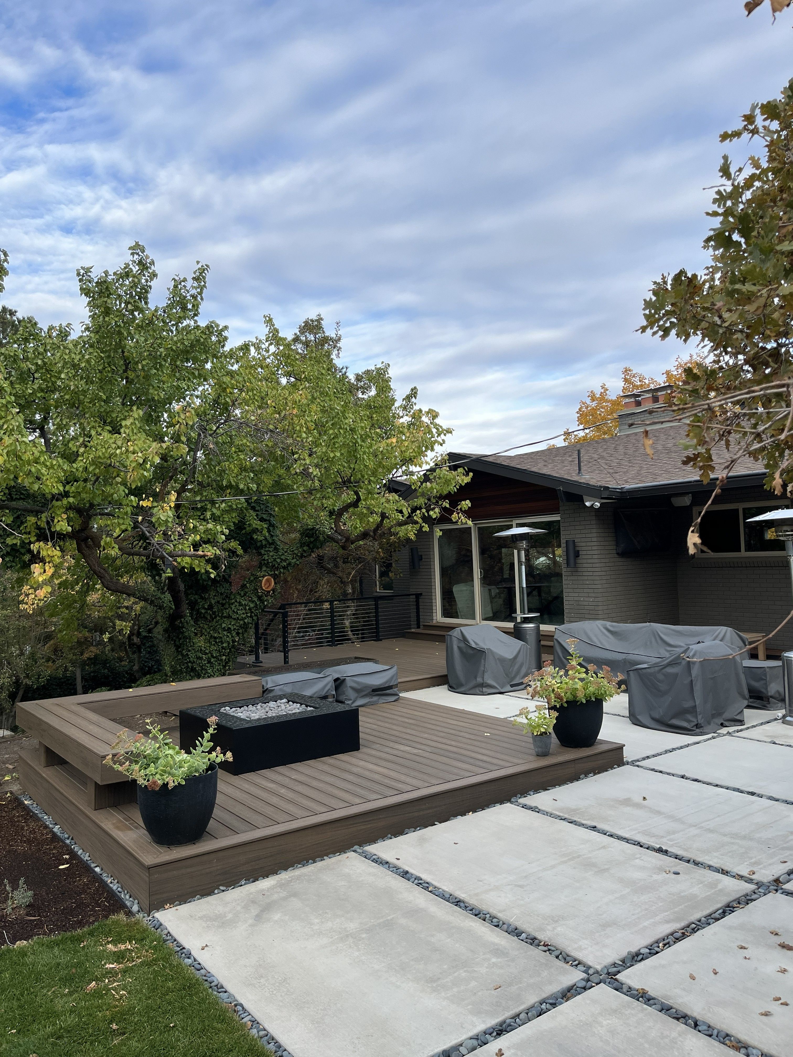 Trex deck with built-in benches and fire pit in Holladay, Utah.