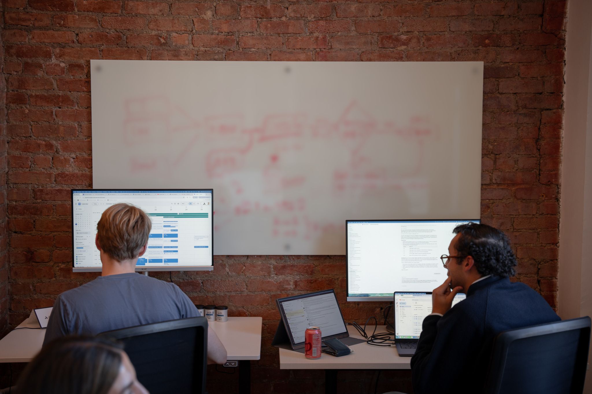 Avallon engineers working in front of a whiteboard claims workflow