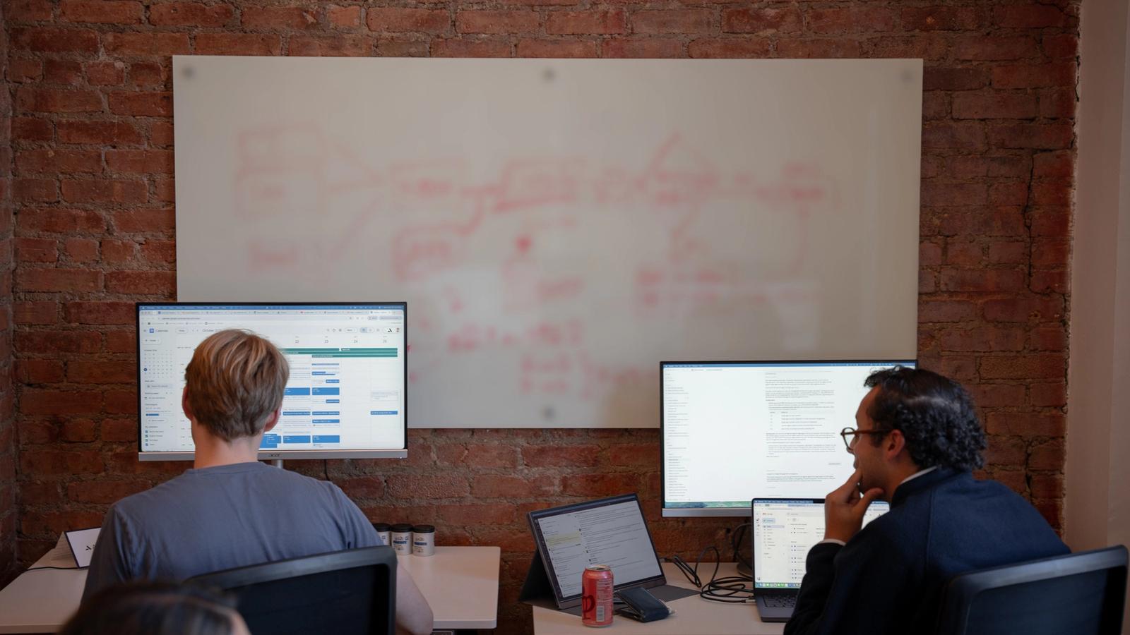 Avallon engineers working in front of a whiteboard claims workflow
