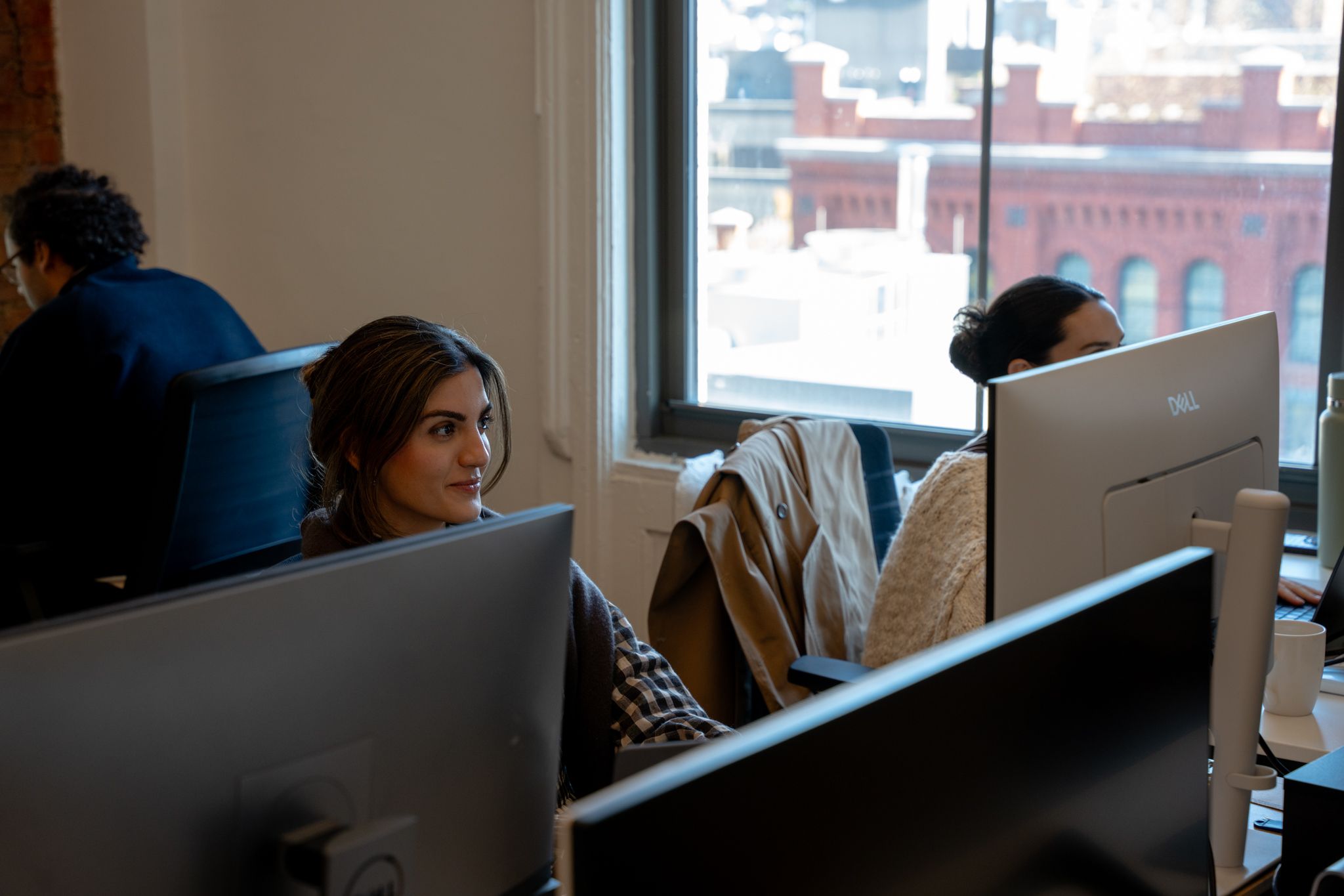 Avallon team working at their desks by the office windows