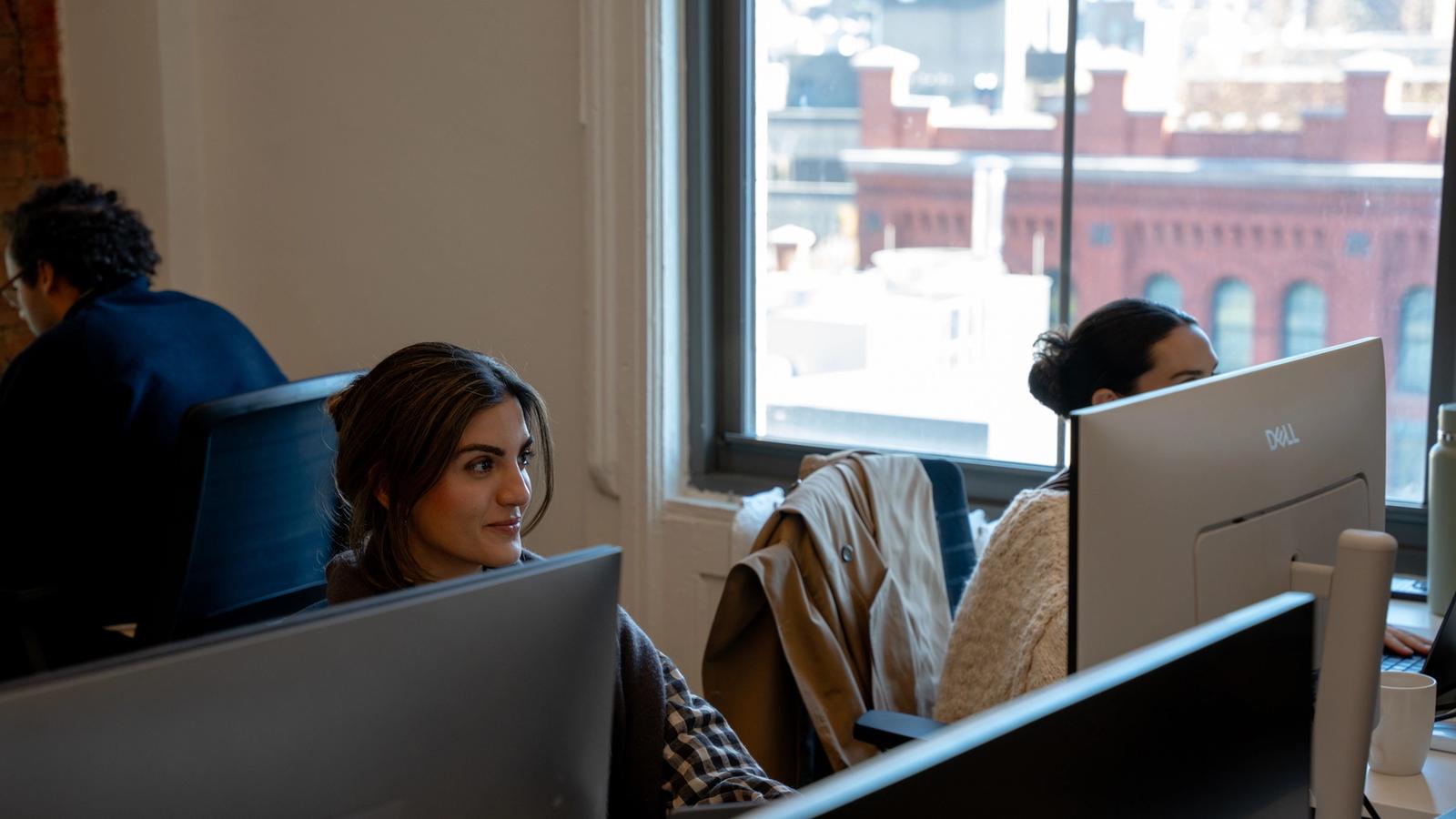 Avallon team working at their desks by the office windows