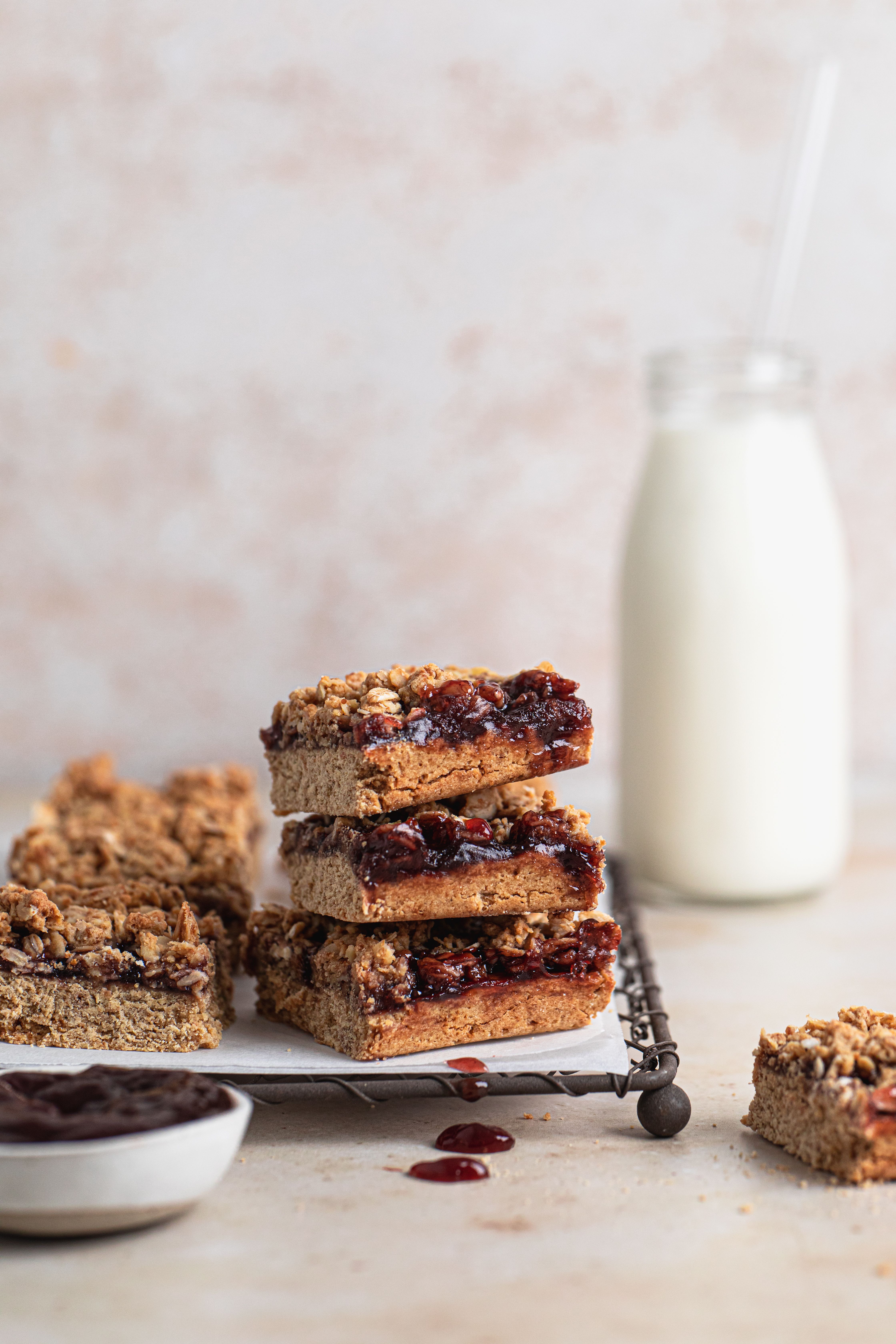 Plum crumble bar stack with jam oozing out.