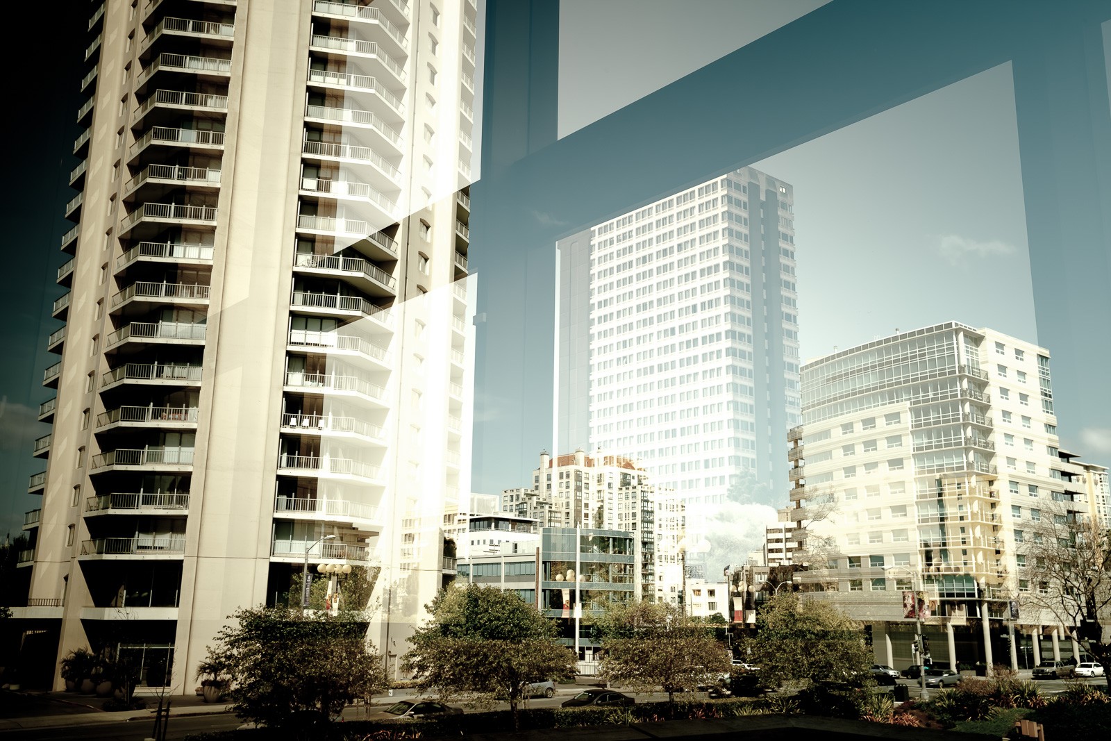 A San Francisco glass tower photographed for what its surface reflects rather than what it is. Two neighbouring buildings appear merged in the glass - the city doubled and abstracted, the tower itself invisible.