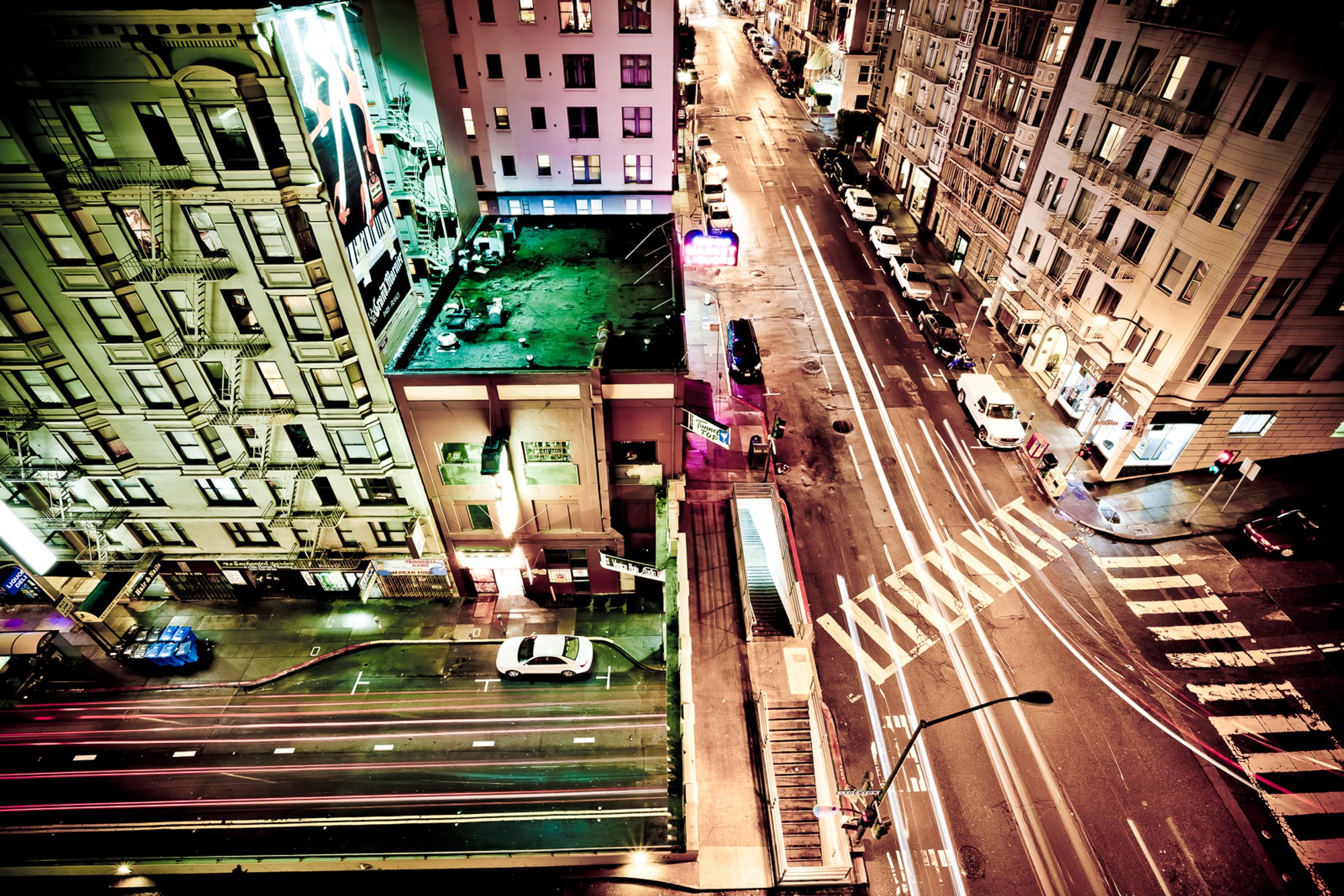 San Francisco from above, a long exposure turning the street grid into light trails that converge and diverge across the frame. The city as a pattern of movement, seen from high enough that individual streets become lines.
