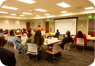 Funders seated at tables during a Funders Learning Lab session