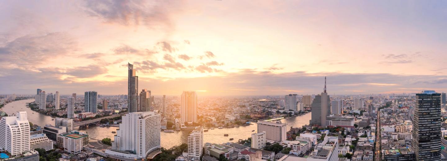 Bangkok skyline glowing at dusk