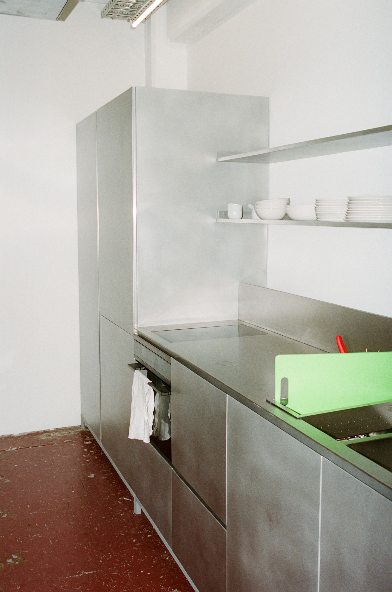 A minimal stainless steel kitchen in a shared workspace