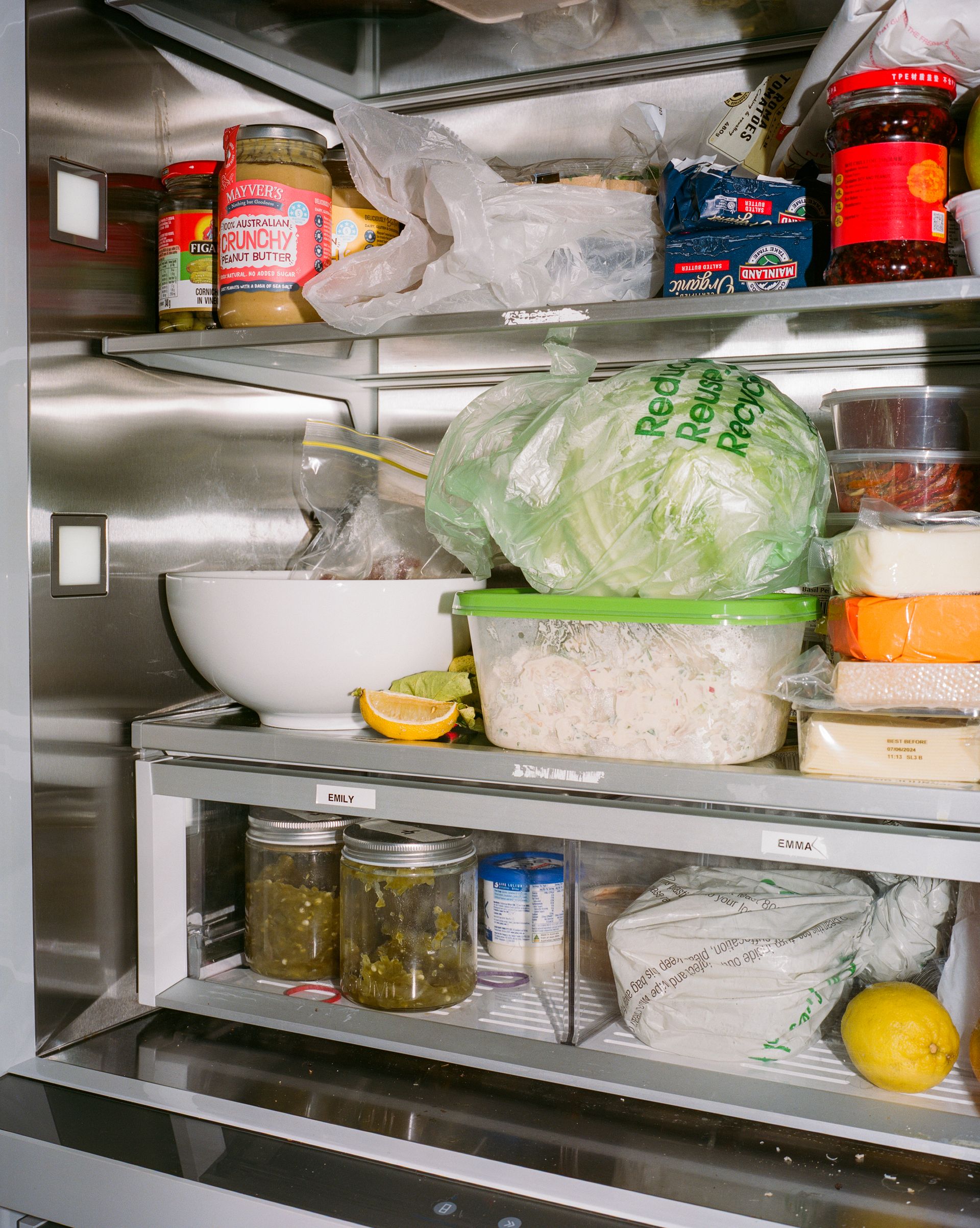 A close up photo of the contents of a shared fridge in a creative office