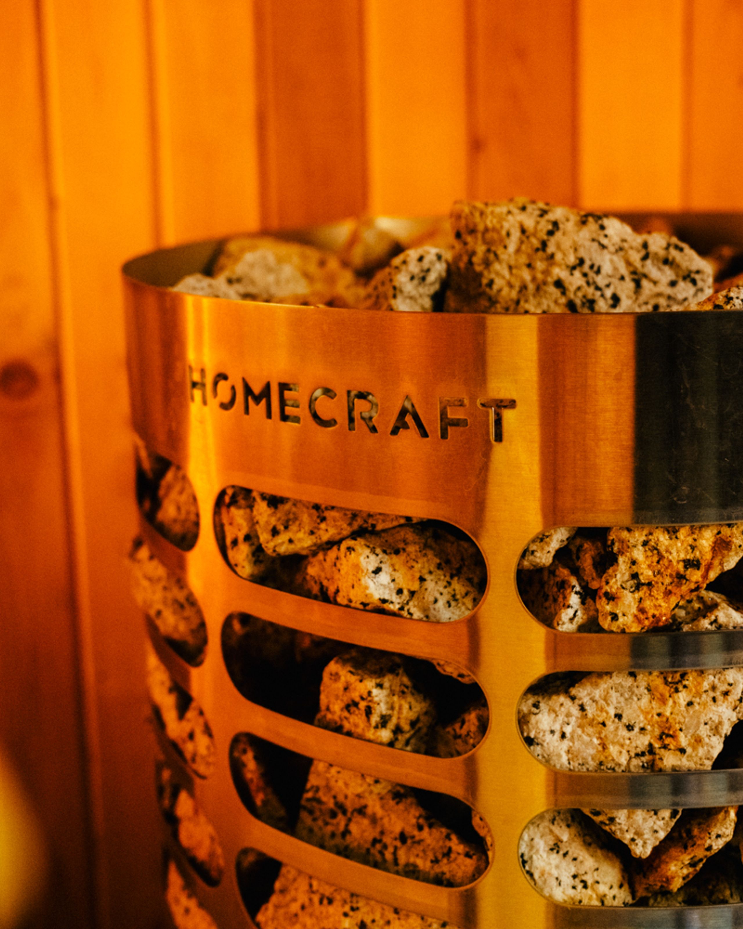 Heater stones surrounded by warm timber inside an Aerth sauna.
