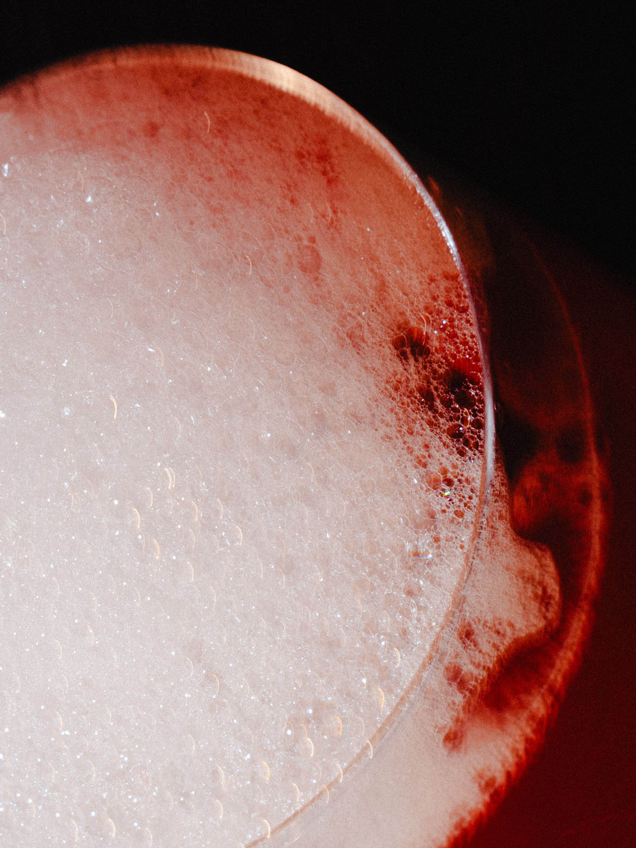 Close-up of a foamy pink cocktail.