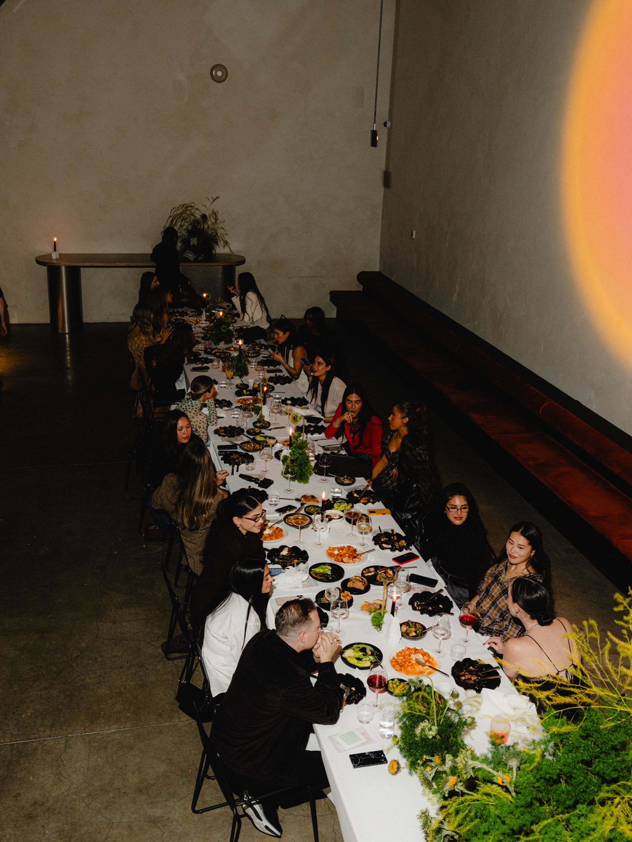 Guests gathered around a long dining table at an Ellipsis event.