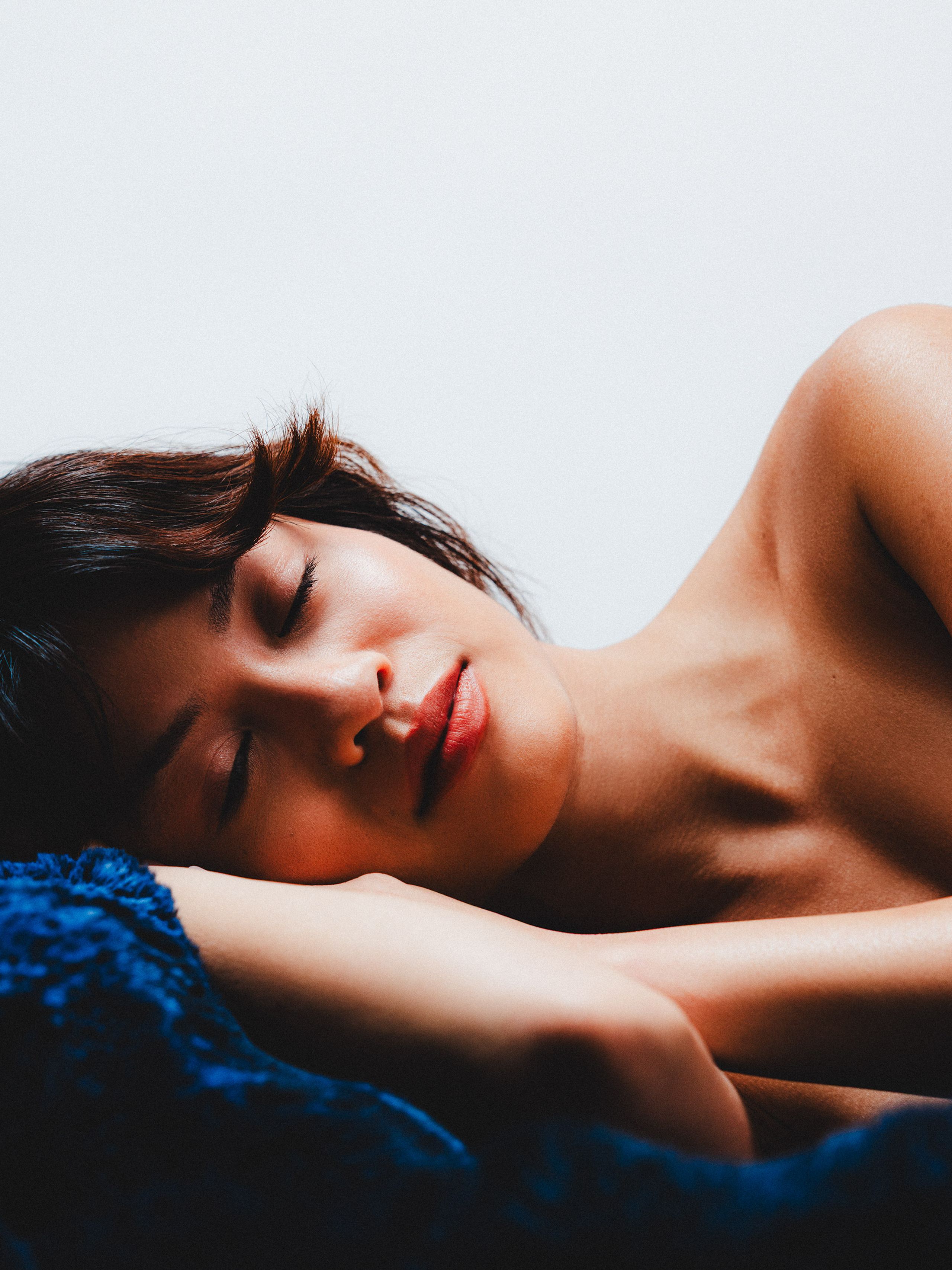 Reclining portrait resting on a blue towel.