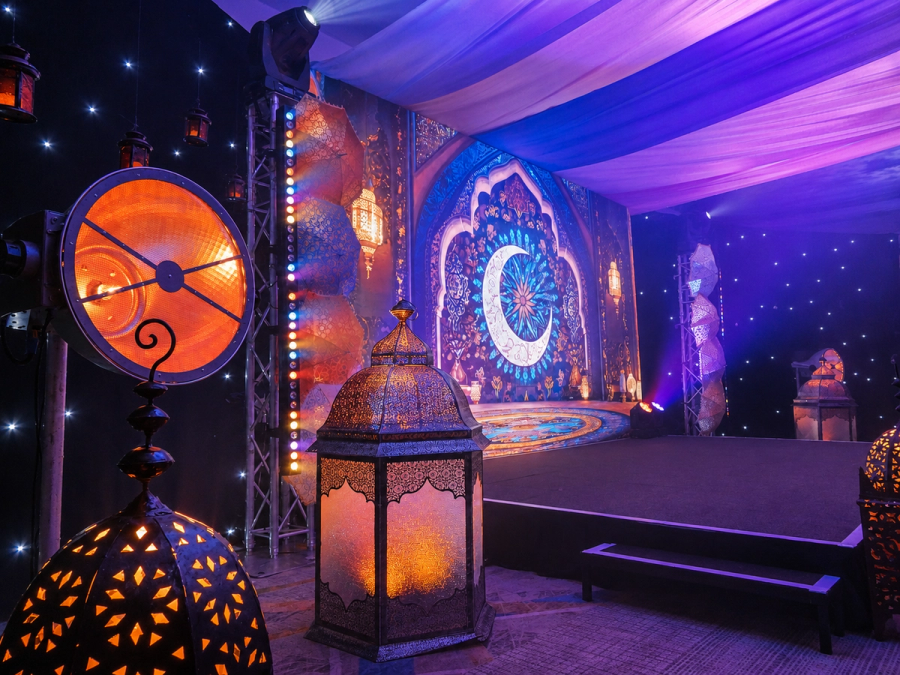 Creative event space featuring vibrant lighting, decorative lanterns and immersive stage design