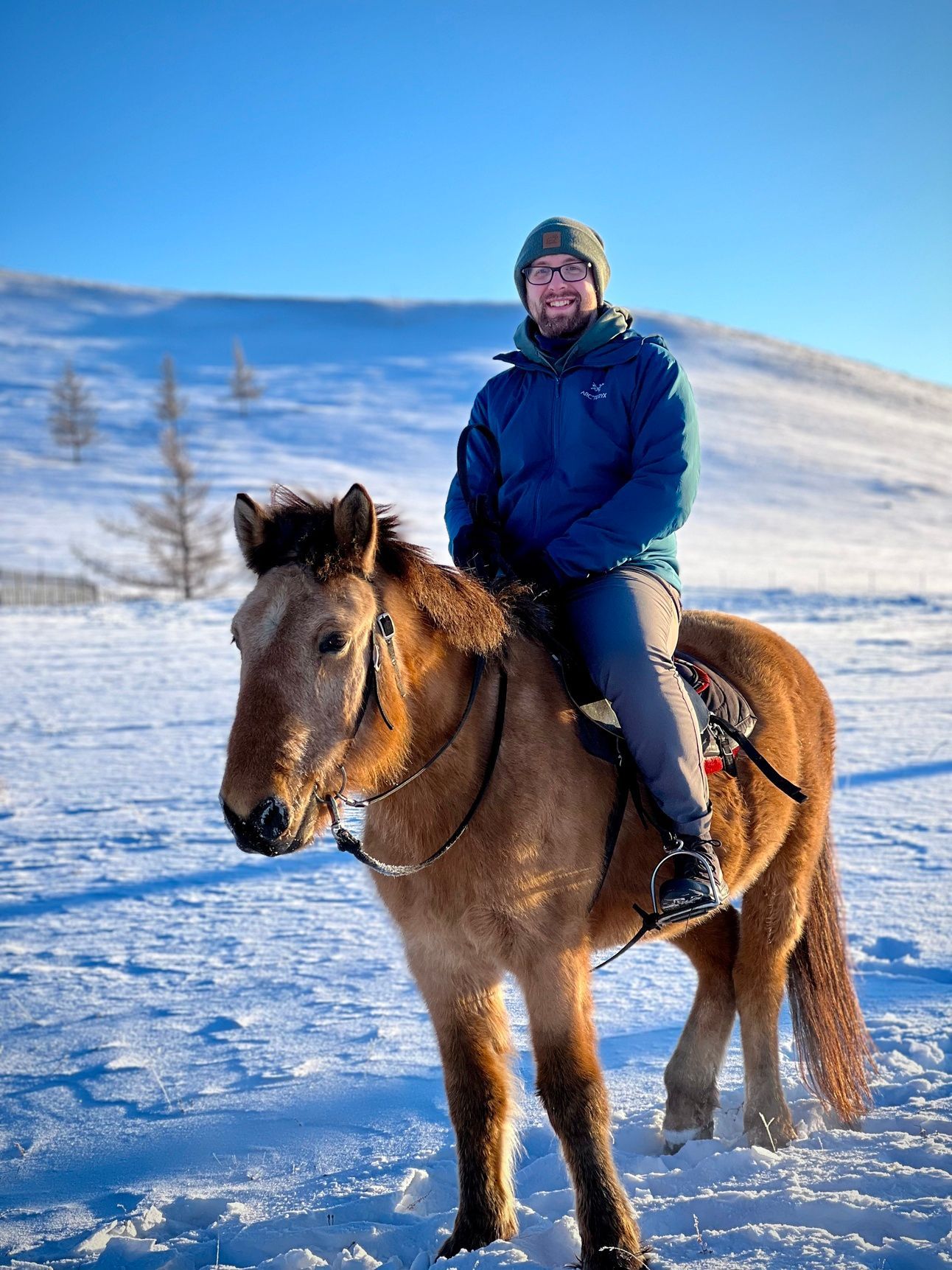 A photo of Mike riding a horse in -32 degree weather in Mongolia