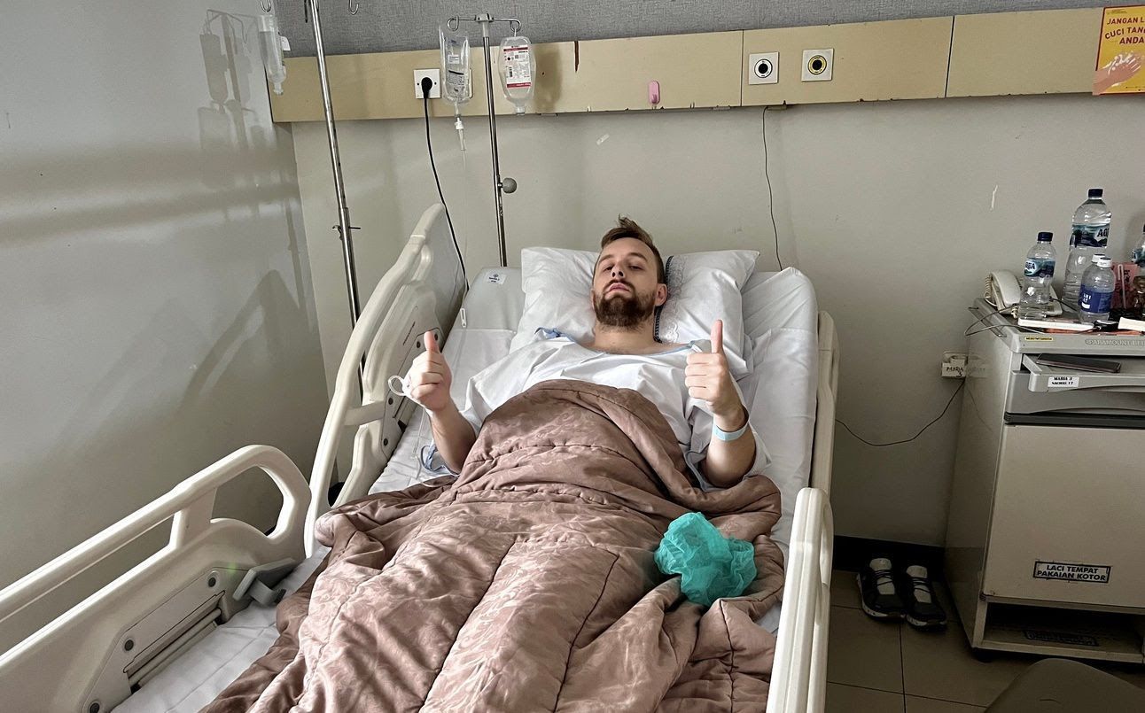 A photo of me pretending to be okay after my surgery in Indonesia