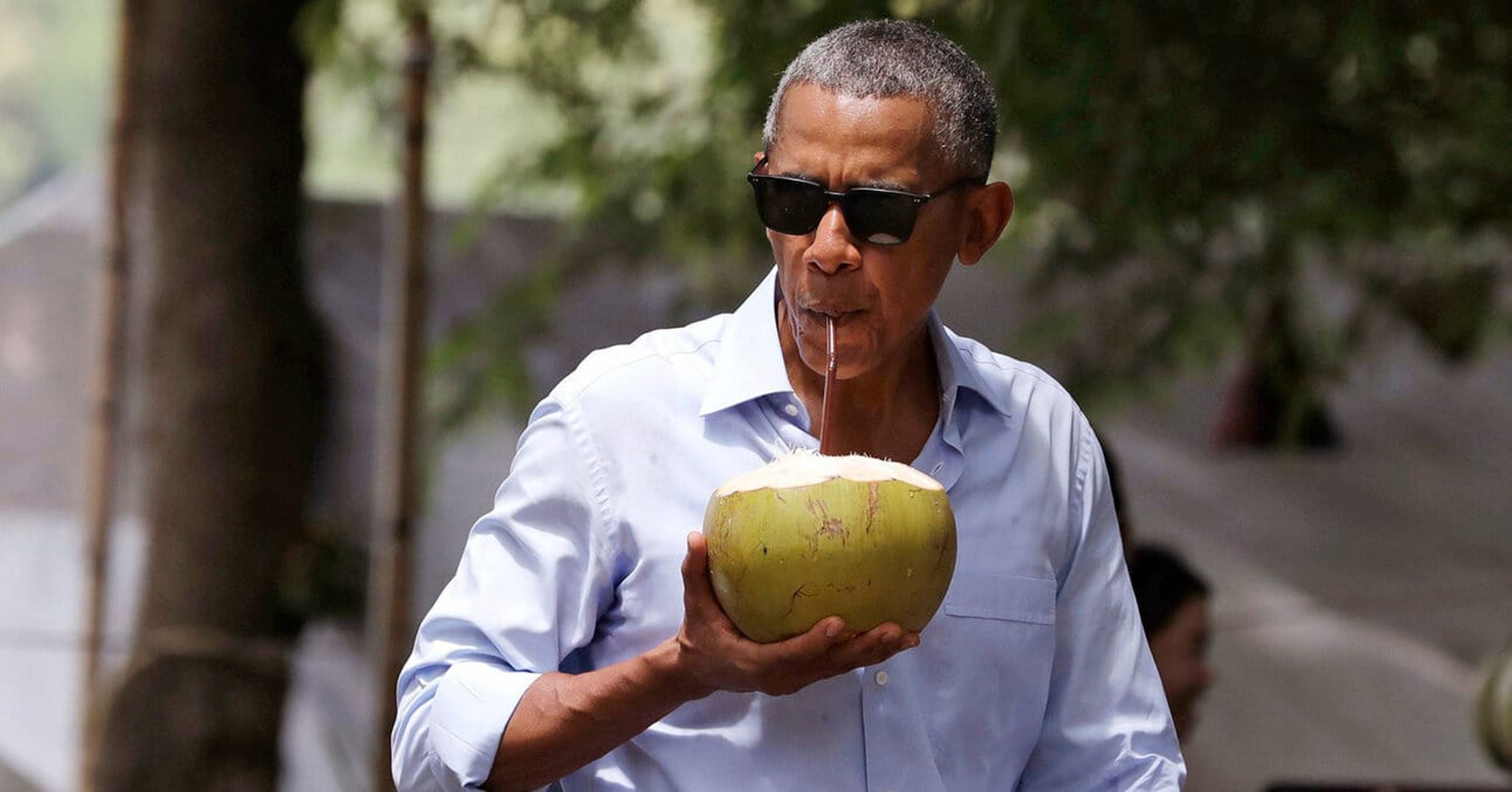 A photo of Obama drinking out of a coconut in Laos in 2016