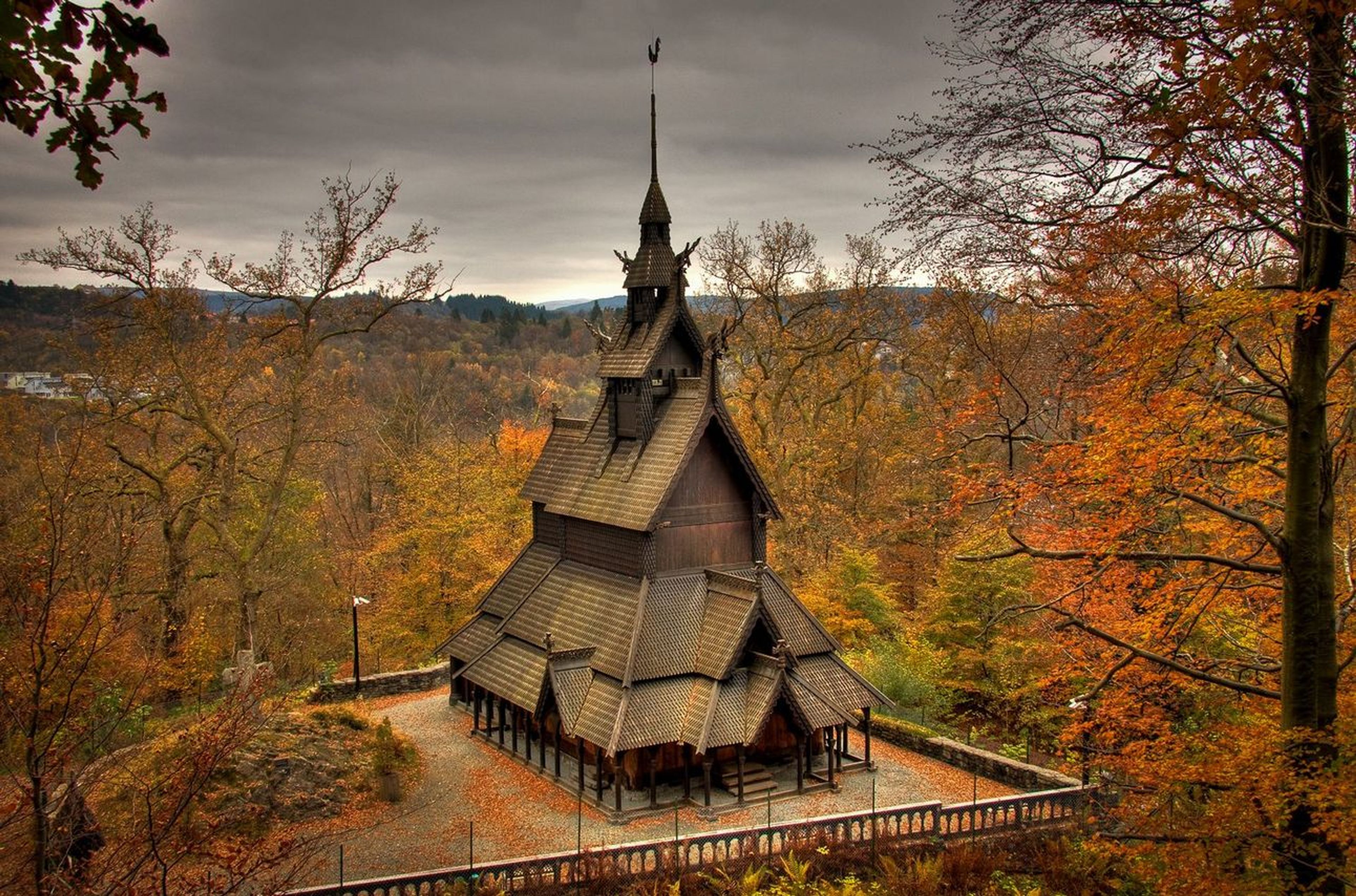 An angled and vertical church amongst fall-colored trees