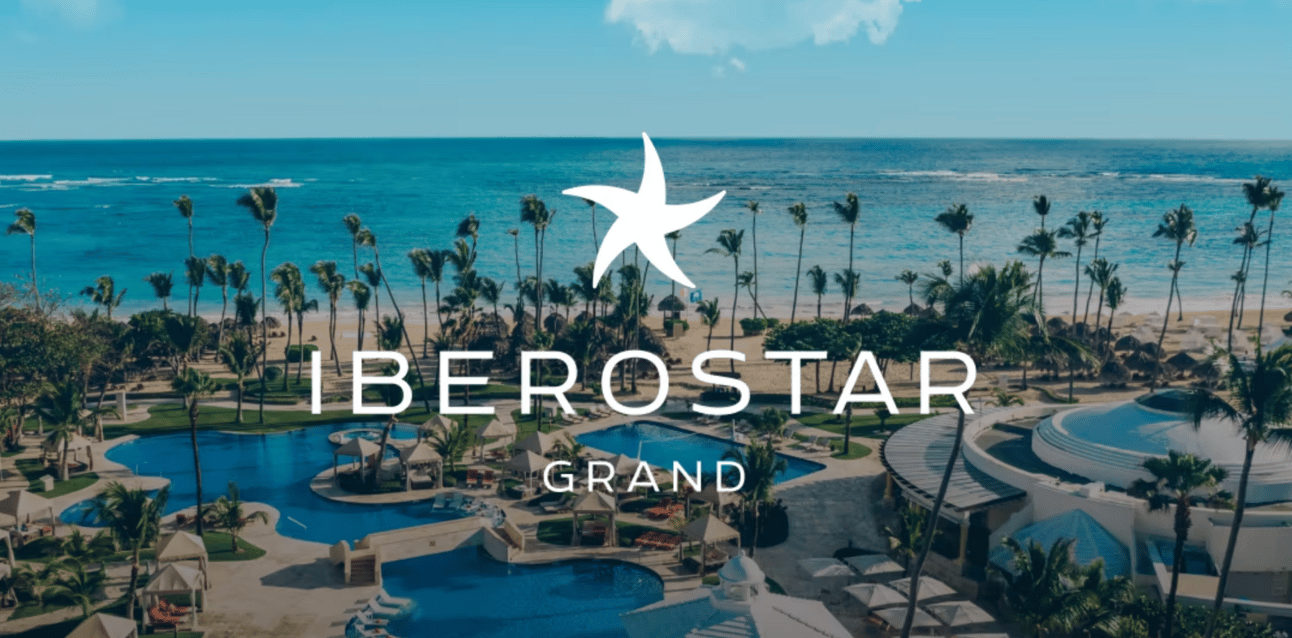 The Iberostar logo in front of a nice beach property
