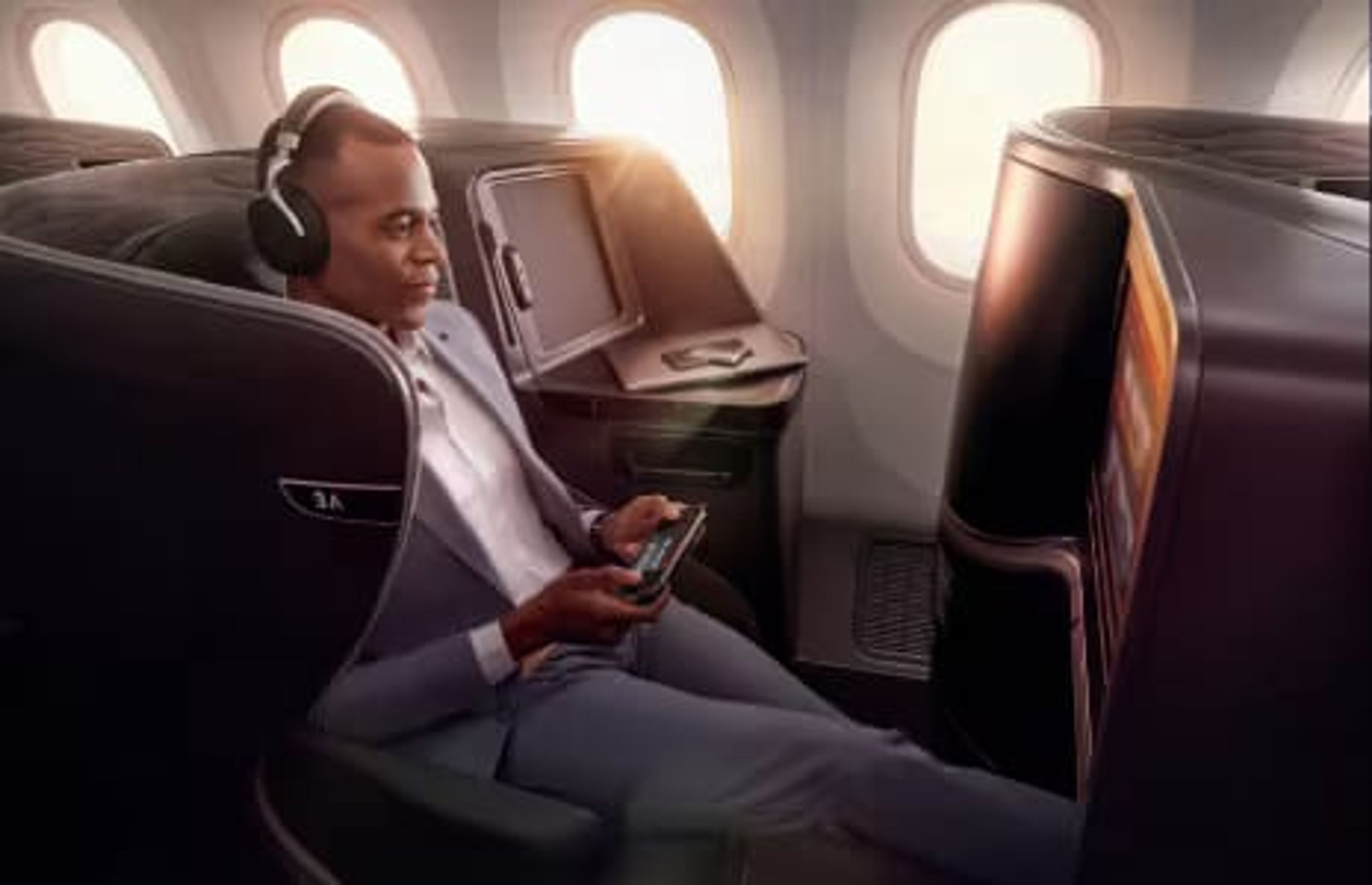 A man sitting in a business class suite