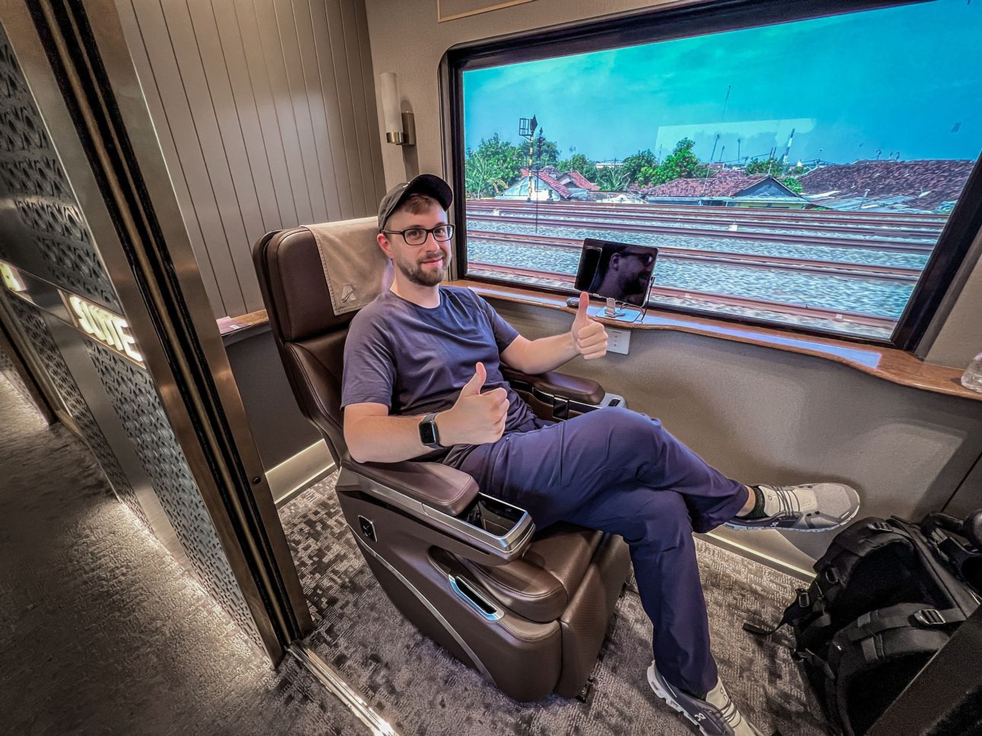 Mike sittingin his luxury-ass train seat