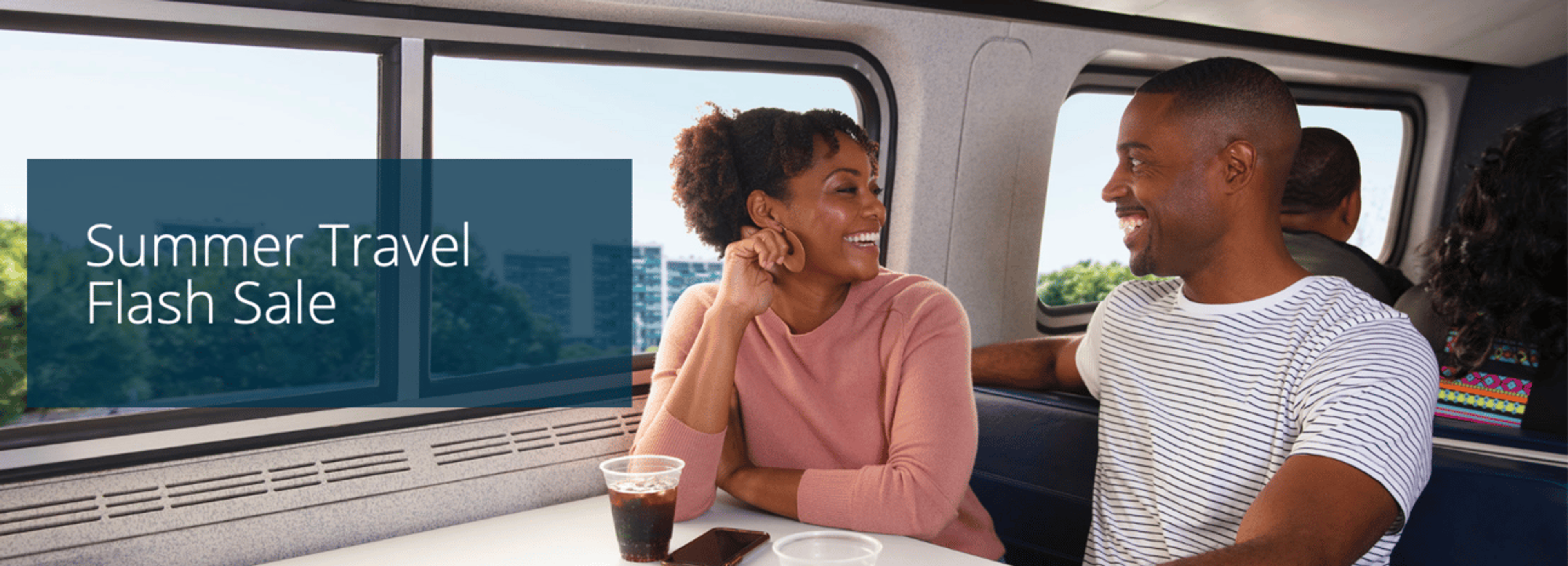 An image of two people sitting on a train