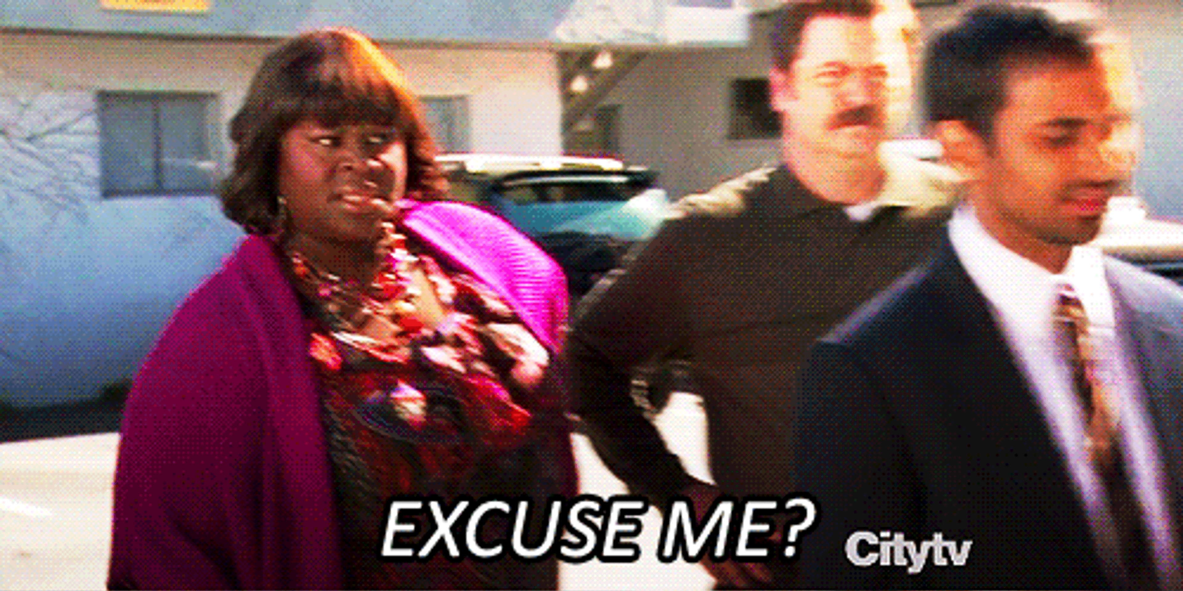 A woman mouthing "Excuse me?"