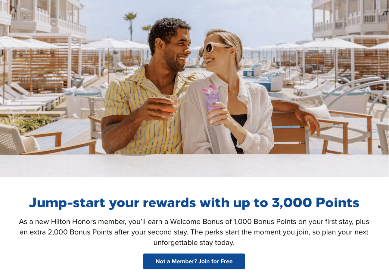 An image of a man and a woman sipping drinks at a Hilton property that encourages you to sign up for 3,000 bonus points