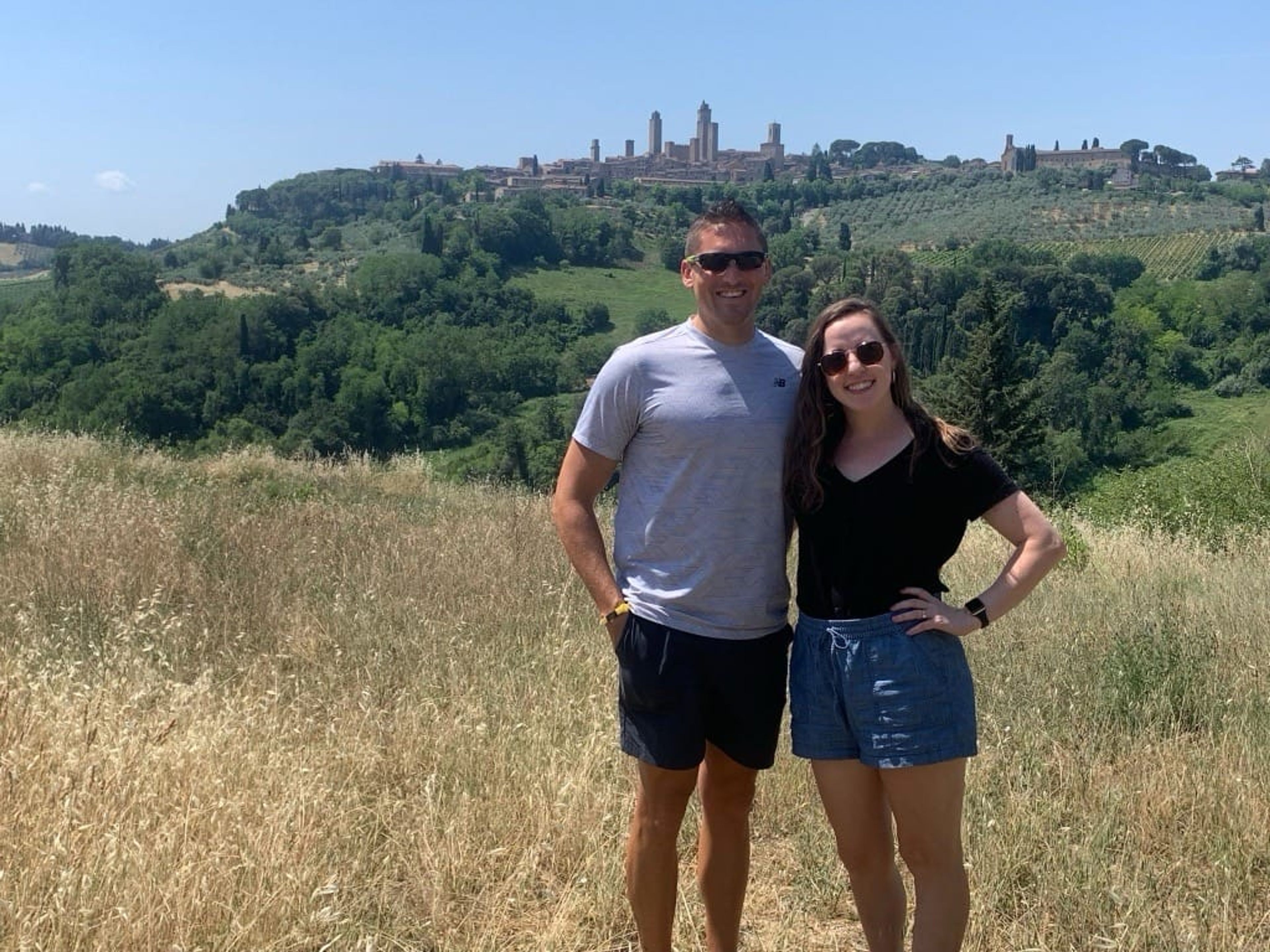 Happy points traveler with her trusty sidekick outside San Gimignano.