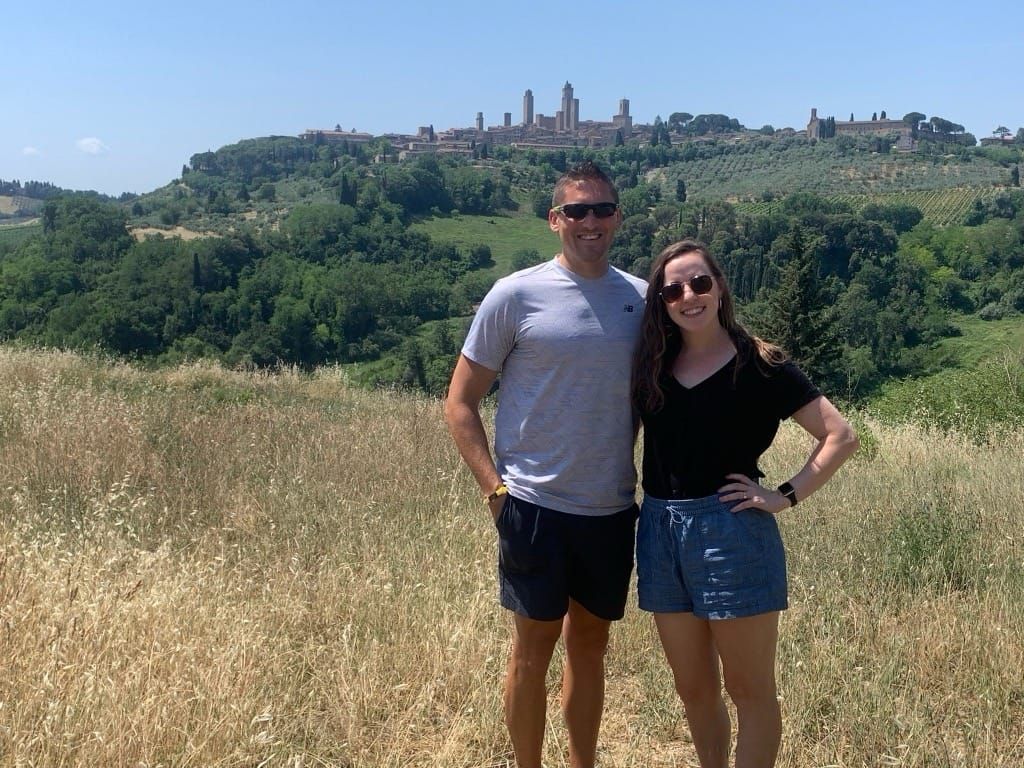 Happy points traveler with her trusty sidekick outside San Gimignano.