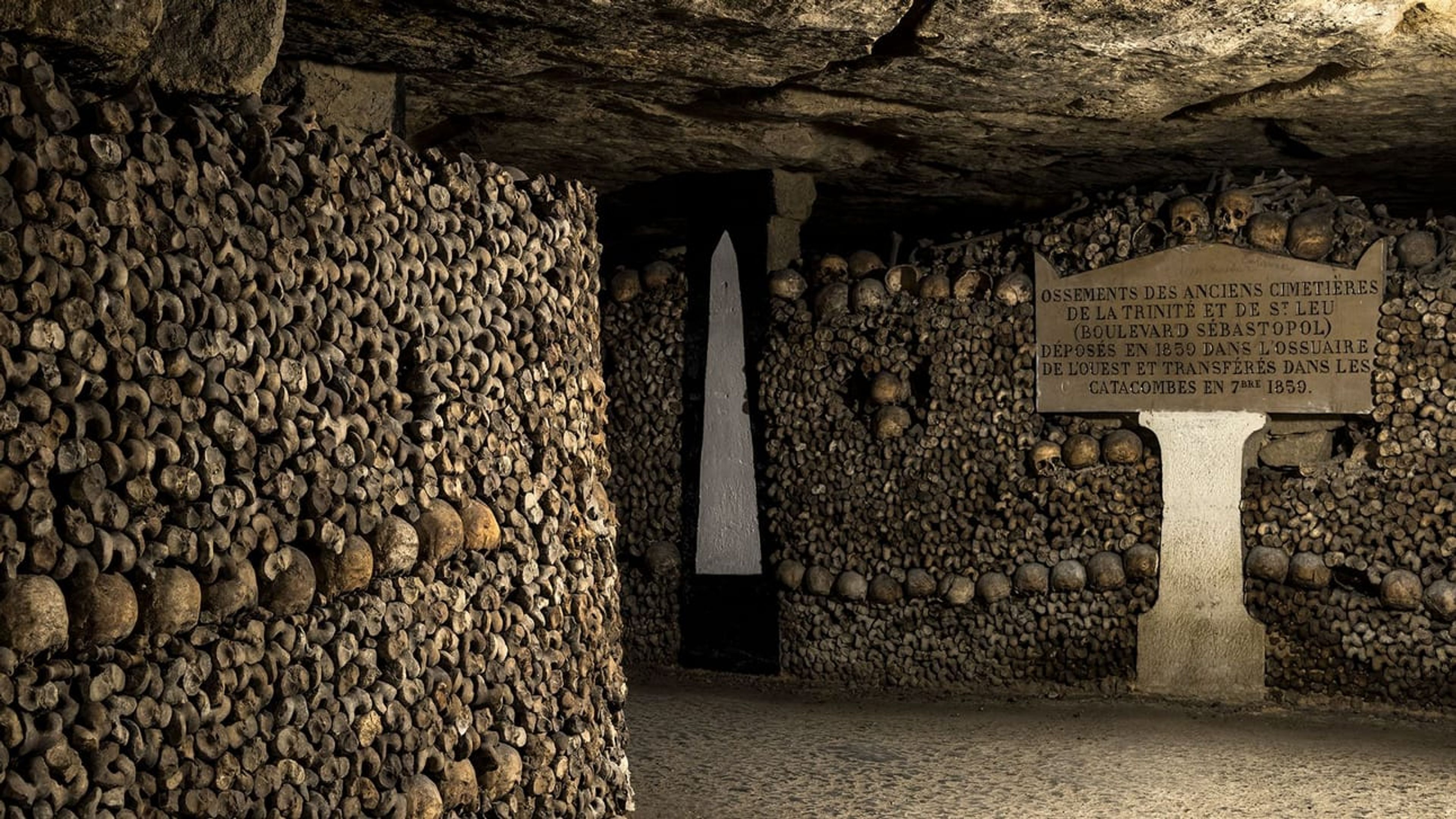 An underground photo of the catacombs lined with bones