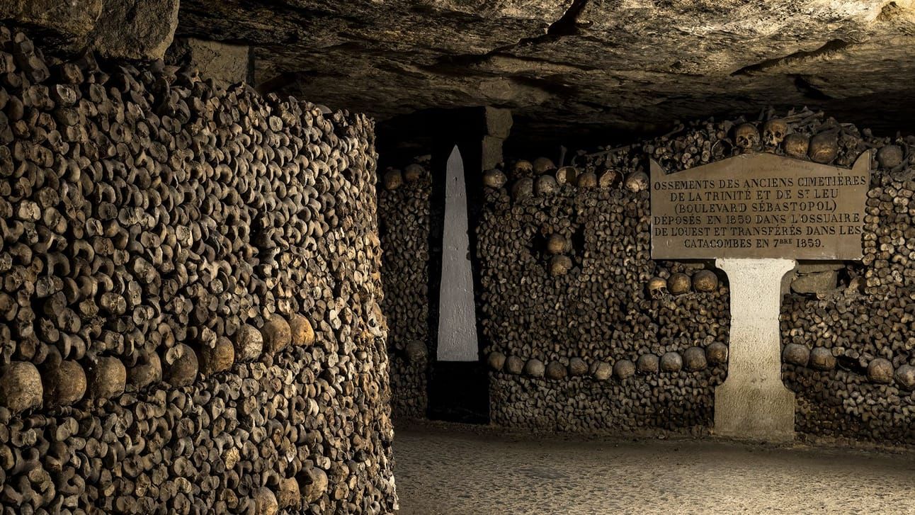 An underground photo of the catacombs lined with bones