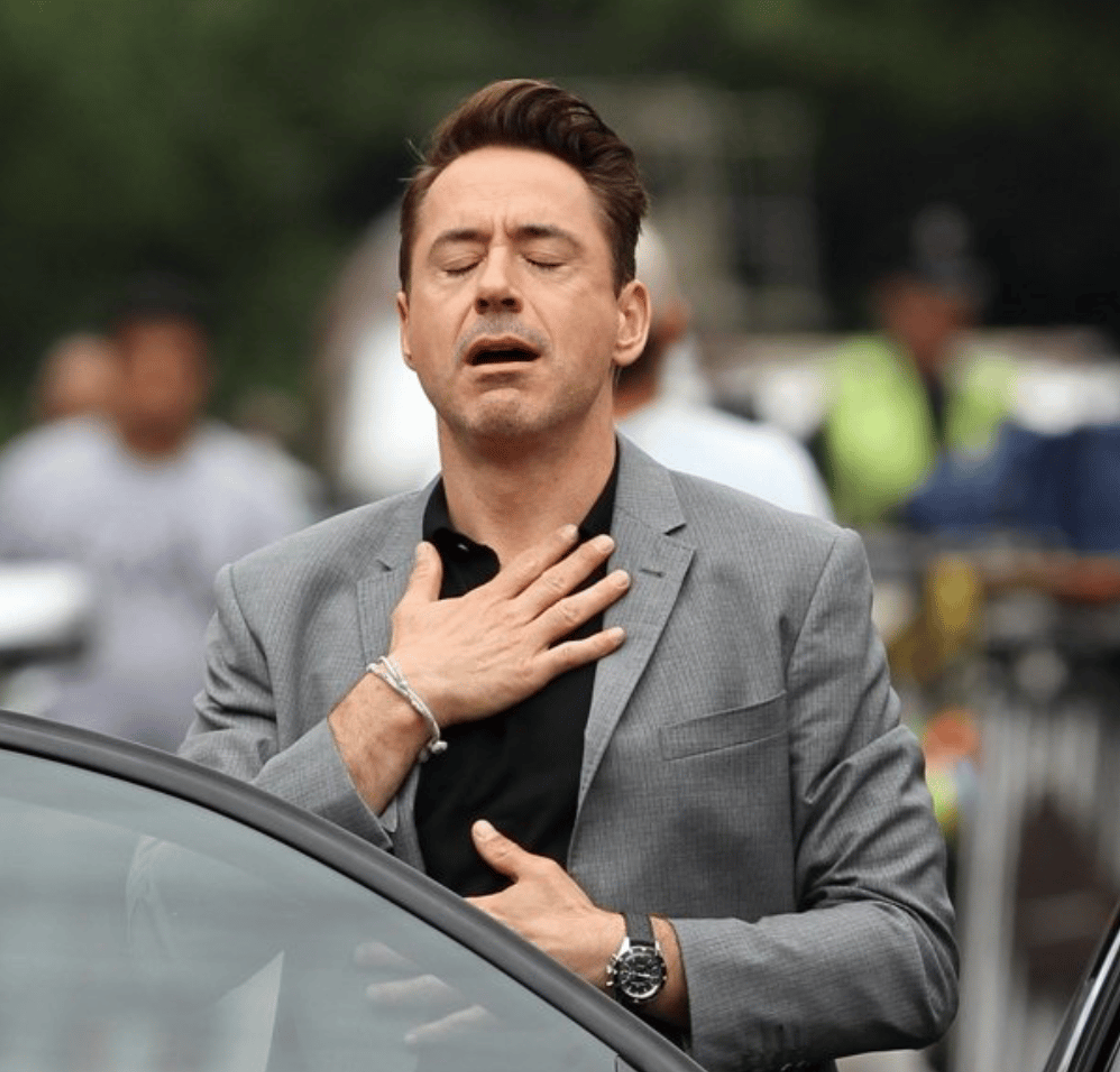 A meme of Robert Downey Jr. exhaling with his hands over his chest.