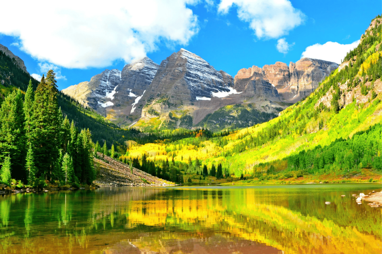 A landsape image with a lake, trees, and mountain in the background